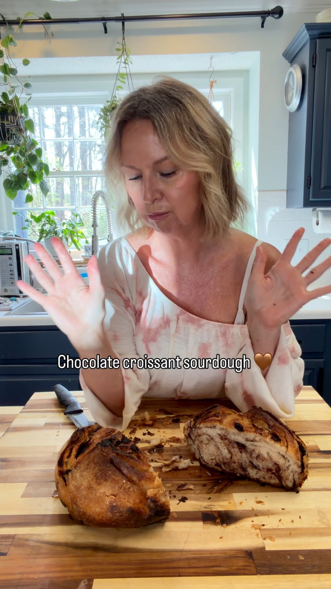 Chocolate croissant sourdough might be my favorite loaf yet 🤎
Flaky, buttery layers with melty chocolate in every bite… and yes—it’s as good as it looks.

Linking my everyday kitchen favorites + my go-to sourdough tools 🥖✨

Recipe:

Rich, buttery sourdough with delicate, flaky layers and ribbons of melted chocolate
Makes 2 loaves
⸻
Starter Feed
   •   125 g warm water
   •   125 g flour

Mix and let rise until doubled and bubbly.
⸻
Dough
   •   200 g active starter
   •   650 g warm water
   •   50 g olive oil
   •   1000 g bread flour
   •   4 tsp salt
⸻
Chocolate Layer
   •   1–1½ cups chocolate chips or chopped chocolate
(semi-sweet or dark works beautifully)
⸻
Instructions
	1.	Activate Starter
Feed starter and let rise until doubled and bubbly.
	2.	Mix Dough
In a large bowl, combine active starter, warm water, and olive oil.
Stir well, then add flour and mix until combined.
	3.	Rest
Cover with a tea towel and let rest in a warm place for 1 hour.
	4.	Add Salt
Sprinkle in salt and mix thoroughly until fully incorporated.
	5.	Second Rest
Cover and let rest another 45 minutes.
	6.	Stretch & Folds
Perform 4 sets of stretch and folds, 30 minutes apart.
⸻
Create Croissant-Style Layers
	7.	Gently stretch dough into a rectangle on a floured surface.
	8.	Sprinkle chocolate evenly across the dough.
	9.	Fold dough over itself (like laminating), layering chocolate between folds.
	10.	Shape into loaves.
⸻
Final Rise
Cover and let rise until puffy and airy.
⸻
Bake
   •   Preheat Dutch oven to 475°F
   •   Score dough
   •   Bake 25 minutes covered
   •   Lower oven temp to 450 , Remove lid, bake additional 20 minutes until golden brown

👉 Place a cookie sheet on the bottom rack to prevent over-browning on the bottom
⸻
Finish
Cool completely before slicing (if you can wait 😉)
Notes

Expect a tender, buttery crumb with light layering—reminiscent of a croissant with a rich chocolate twist.

Bessie & Co.
Southern Roots • Modern Plates
🦋

#sourdoughbread #homemadebread #kitchenfavorites #southerncooking #ltkhome #ltkfood

#LTKdayinmylife #LTKfoodie #LTKHome