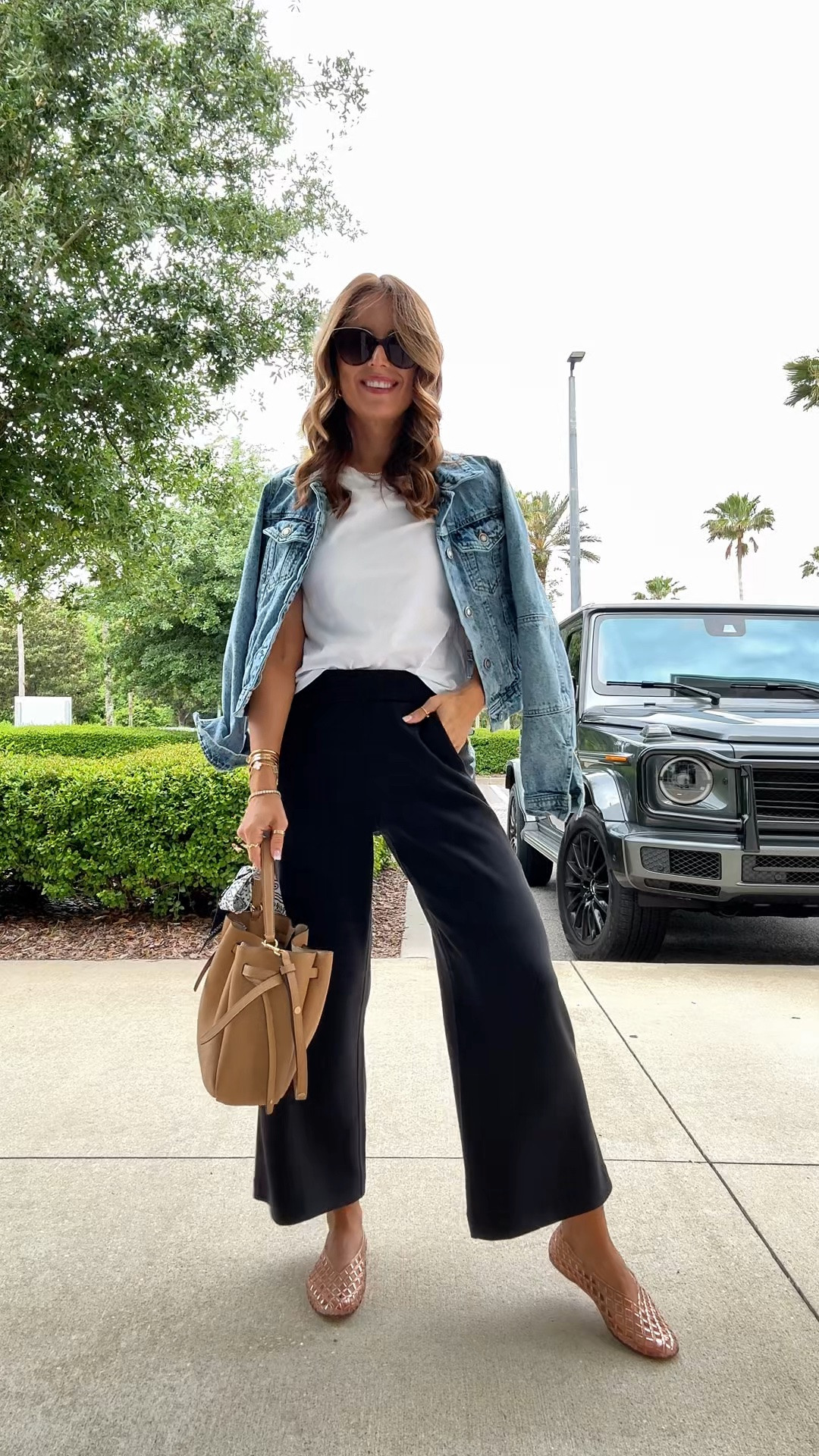 Travel outfit. Elevated casual. I just love these new wide leg modal blend pants! Wearing XXS and has 25” inseam. So soft and comfortable for travel, everyday, and the office, too. The best white t-shirt in XS. XS in denim jacket. Jelly ballet flats are TTS. Tory Burch Romy Bucket bag.

#LTKootd #LTKTravel #LTKPetite