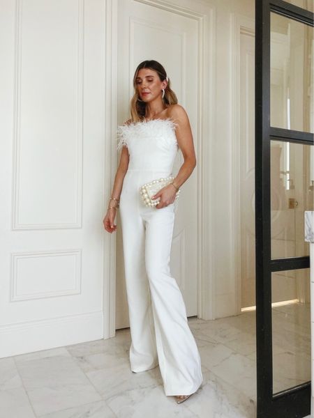 Holiday party outfit inspiration! Loving the feather trend this season. White feather jumpsuit, pearl clutch, acrylic heels. Cella Jane. 

#LTKHoliday #LTKstyletip