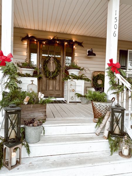 Cozy Christmas porch with layers of Christmas tree decor and wreaths 

#LTKSeasonal #LTKHoliday #LTKhome