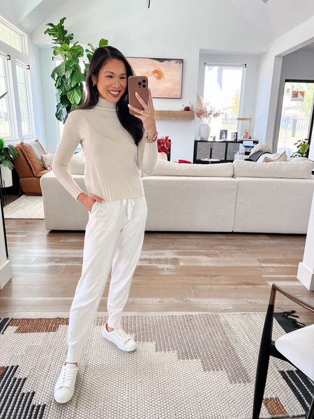 Winter white outfit with sweater joggers, a cashmere turtleneck sweater and white sneakers. Keeping accessories simple with Nasreen x Kendra Scott earrings. 

#LTKtravel #LTKHoliday