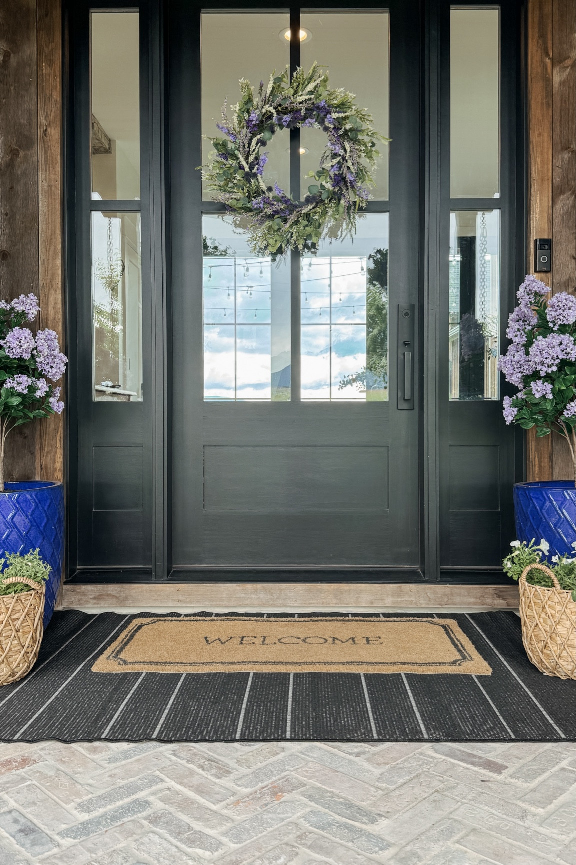 Out summer front entryway!! New wreath, which is the most realistic and gorgeous I have ever seen!!

Plus new lilac plants by the front… and the good news is the deer can eat these all they want!  Also loving our new entryway rugs against the brick. So happy with this final look!