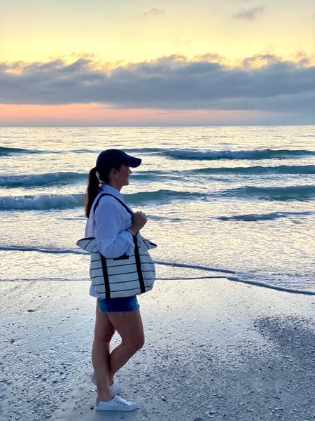 Cutoff denim shorts, white tennis sneakers, a white  long sleeve button-down shirt, and a baseball cap make the perfect outfit for watching sunsets at the beach. Add a water resistant tote to carry essentials and you’re ready to go! 
beach outfit casual style, vacation, resort wear, summer outfit,

#LTKSeasonal #LTKswim #LTKitbag