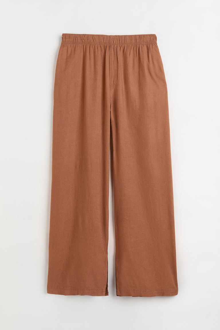 Conscious choiceTrousers in a linen and viscose weave with a high, elasticated waist, fake fly, d... | H&M (FR & ES & IT)