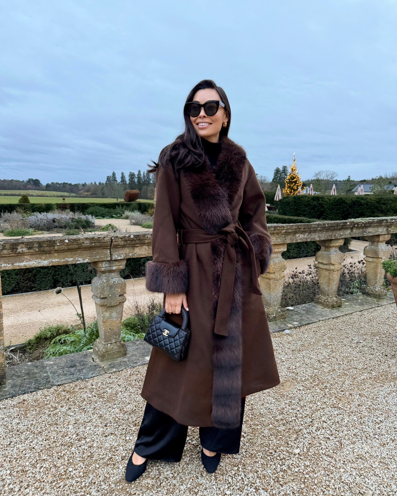 Kat Jamieson at Estelle Manor wearing a faux fur coat, winter outfit, chocolate brown coat, LPA coat, Chanel bag, Chanel sling back punks, classic style. 

#LTKHoliday #LTKootd #LTKSeasonal