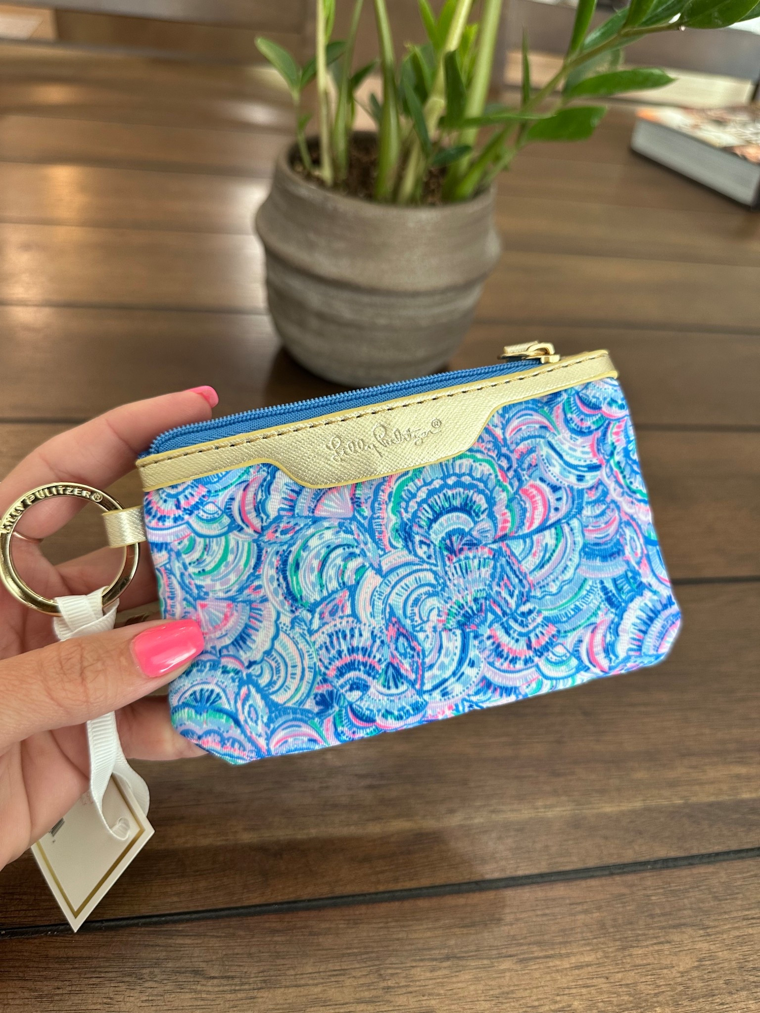 This Lilly wallet is so cute and perfect for keeping cards and IDs handy. It’s small and has a key ring for on the go! Big enough to add a lipstick or other essentials too!