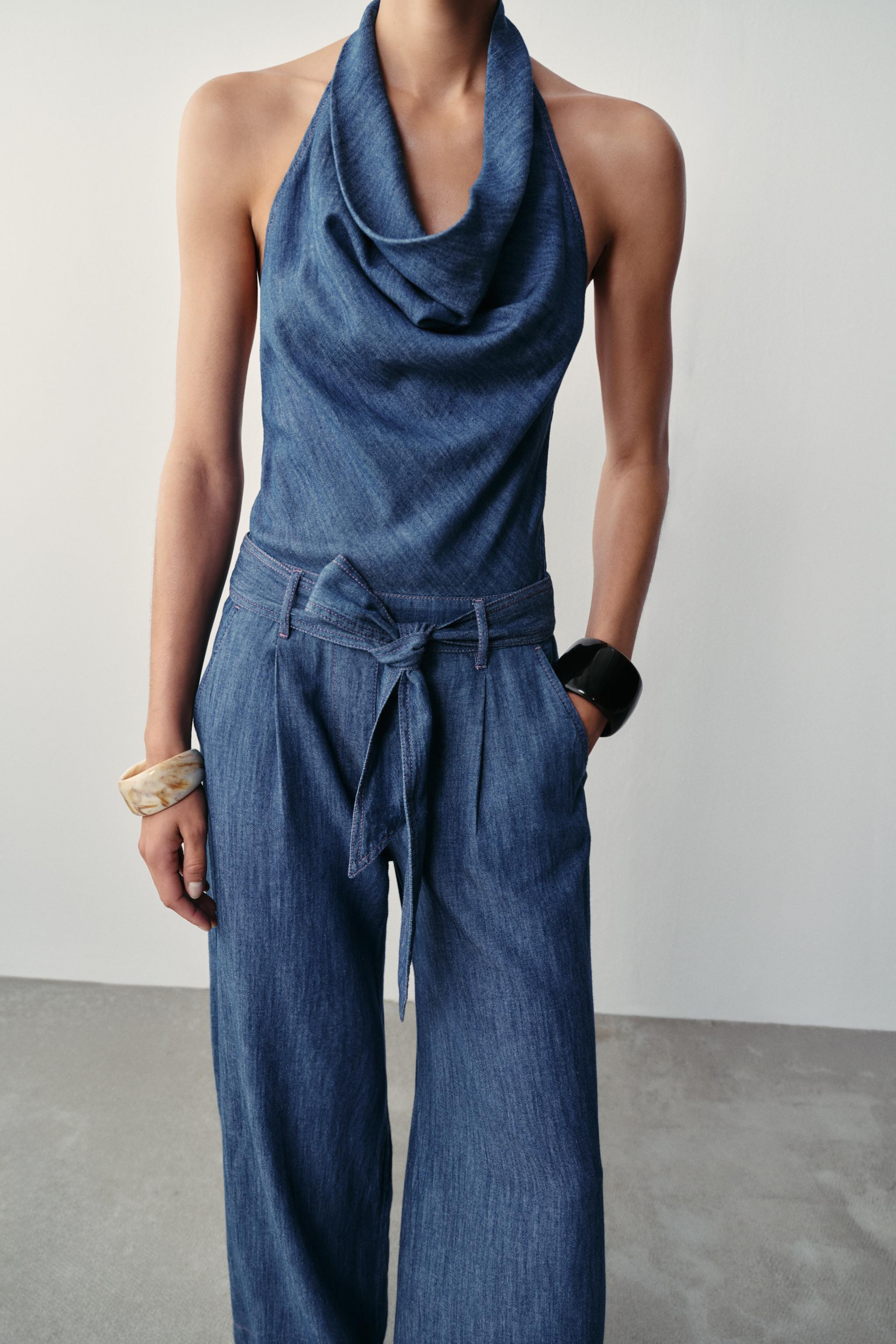 Halter neck jumpsuit with an open back. Features a matching fabric belt with contrast topstitchin... | Zara UK
