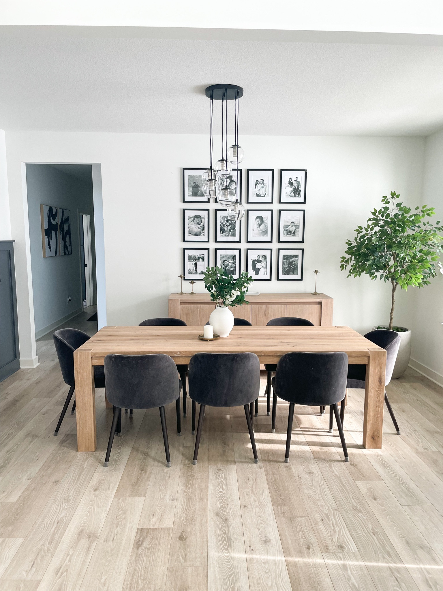 Happy Monday, I think it’s time to share my dining room! I’m still not quite done, but it has come a long way since the white canvas we got when we first built our home. This includes our half wall,  portraits, lighting, and natural color dining table/sideboard. #homedecor #diningroom 

#LTKstyletip #LTKhome #LTKSeasonal
