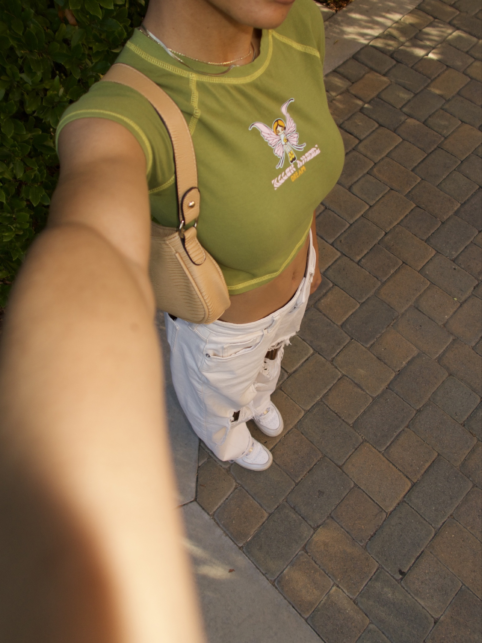 beige shoulder bag, snake skin bag, crop top, graphic tee, ripped jeans, distressed jeans, white jeans, nike air force 1s, white sneakers, gold jewelry, gold necklace 

#LTKfindsunder100 #LTKstyletip #LTKshoecrush