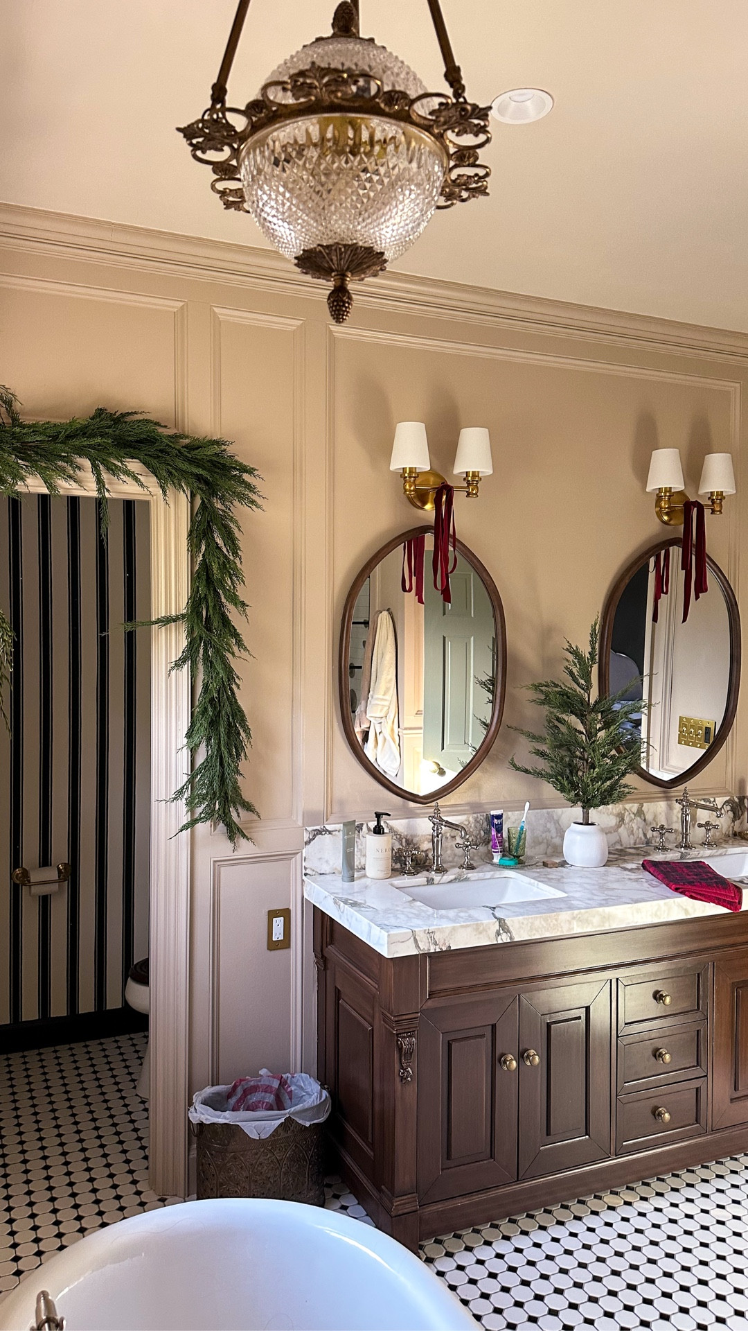 Every time I renovate a room I can’t help but fantasize about how it will look with Christmas decorations and honestly that fantasy propelled me through parts of the primary bathroom renovation this spring / summer.

Some simple garland, a little tree, velvet burgundy bows and some plaid towels…and I couldn’t love it more! 

I used cypress garland above the windows and drilled little cup hooks into the trim to secure them. Added a sprig of cedar on each end and I think it looks perfect!
Do you decorate your bathroom for the holidays?





#holidaydecor #christmas #garland #bathroomdecor #classicchristmas

#LTKSeasonal #LTKHome #LTKHoliday