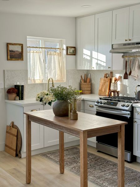 Cottage kitchen decor (unit 3 triplex kitchen)

- Cabinets: wholesale, white shaker from KD stone & cabinets in San Diego
- Counters: Viola Gold Quartz, wholesale from KD stone and cabinets in San Diego 
- Backsplash: Carrara Chateau Herringbone Honed Marble Mosaic from Floor & Decor
- Floors: Willow Bianco Vinyl by Duralux from Floor & Decor 