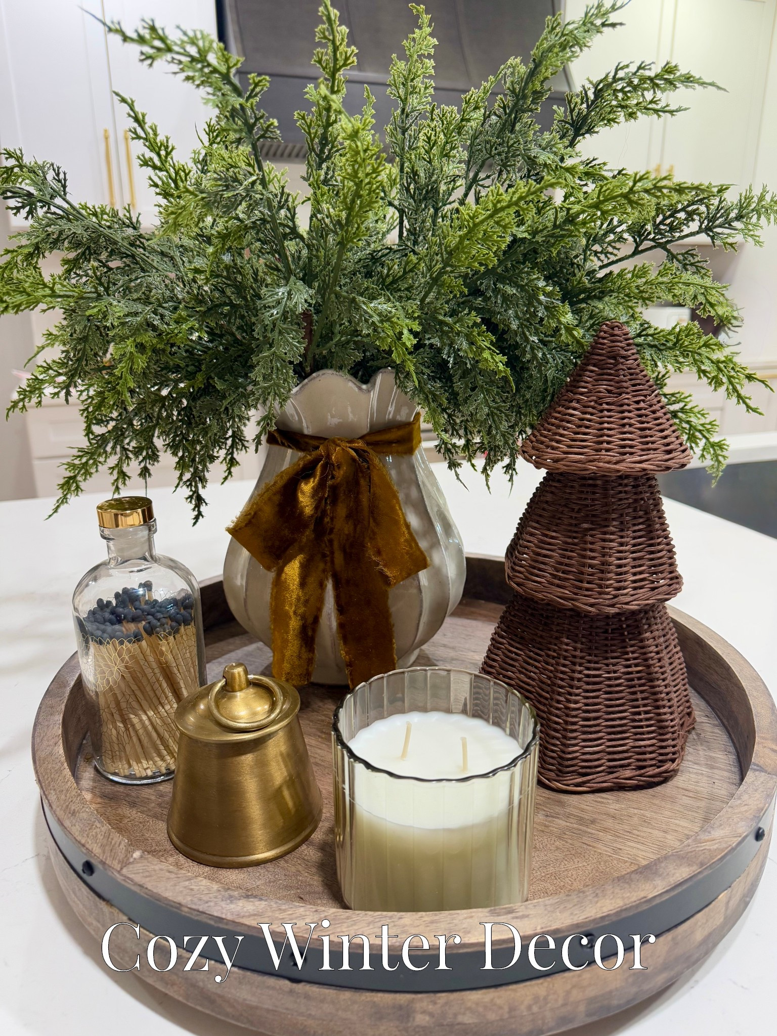 Transitioning from Christmas to cozy winter decor. I switched from pine to cedar stems, added a raw edge velvet ribbon to the vase and kept the rattan tree. I even kept the gold bell candle. The other candle is new from Target. 🤎

#LTKSeasonal #LTKGiftGuide #LTKHome