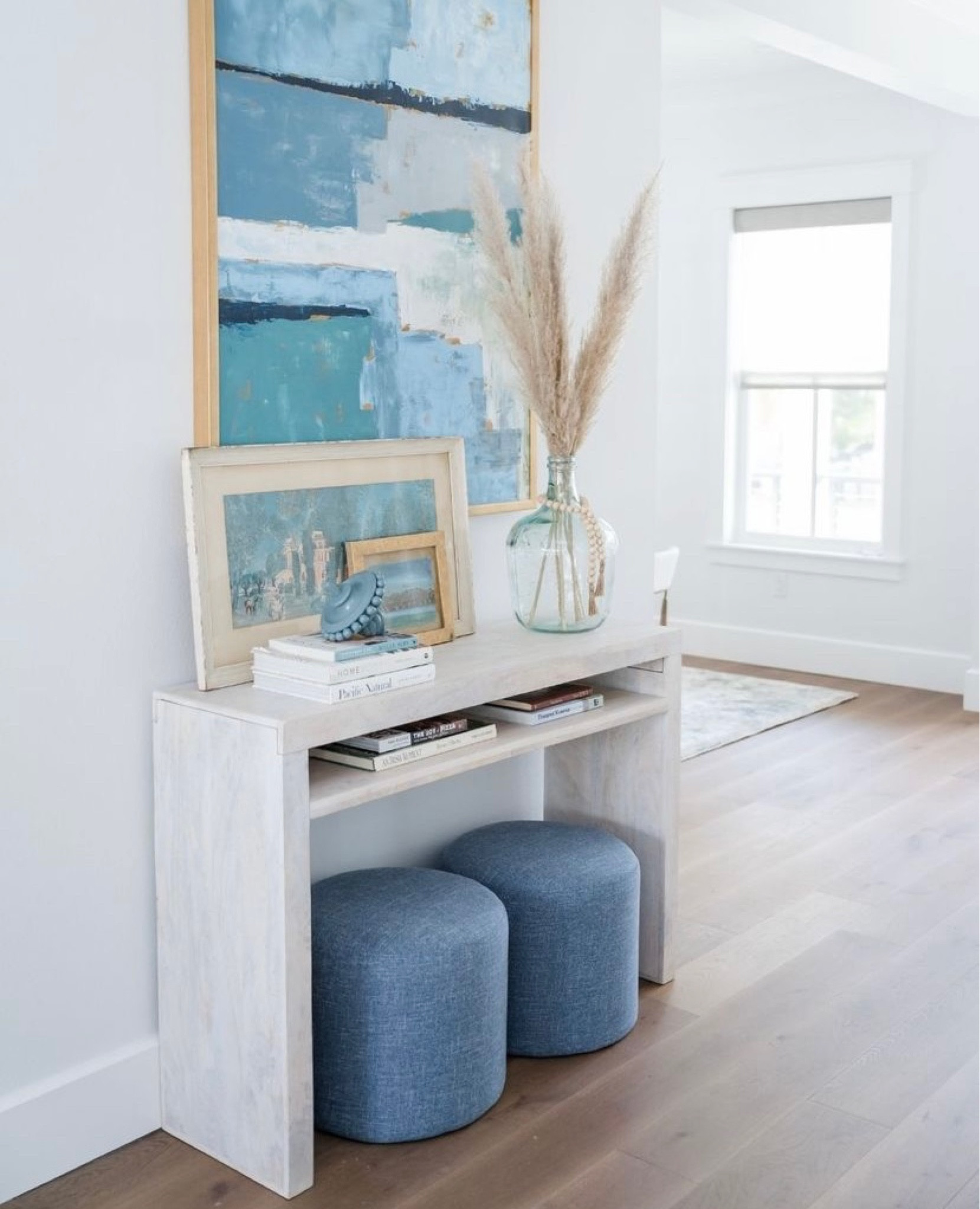 The perfect modern coastal entry way! Boho entry way, interior design, interior design tips, coastal entry way, entry way table, ottomans, coastal interior design, blue decor #LTKFind

#LTKunder100 

#LTKhome