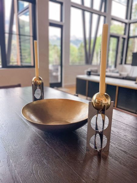 On her dining table, Erin keeps it minimal and elegant with a brass bowl and Jonathan Adler candle holders. The metal and brass are a perfect contrast to the wooden table.

~Team Busbee

#LTKhome