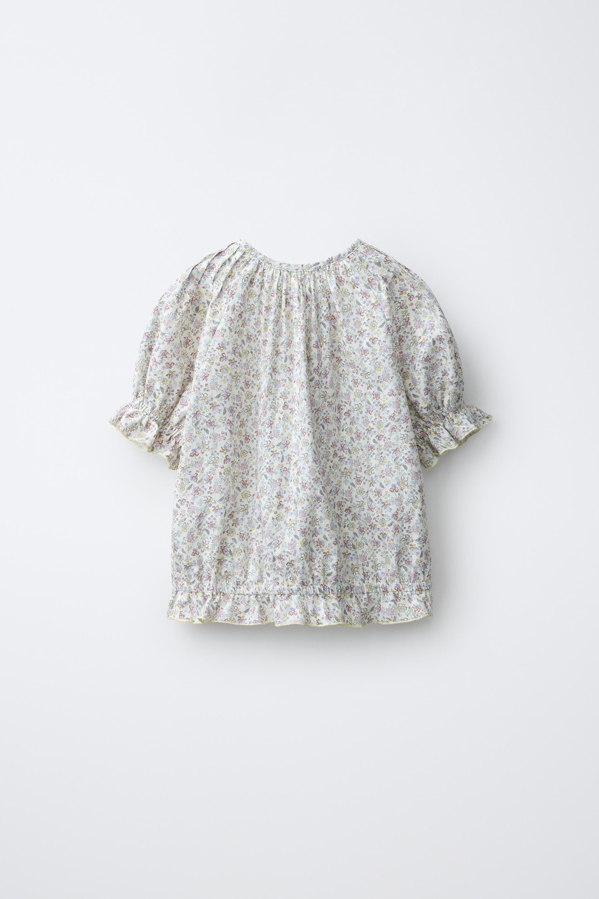 Round neck short sleeve blouse. Teardrop button closure at the yoke. Pintuck detail on the front ... | Zara US