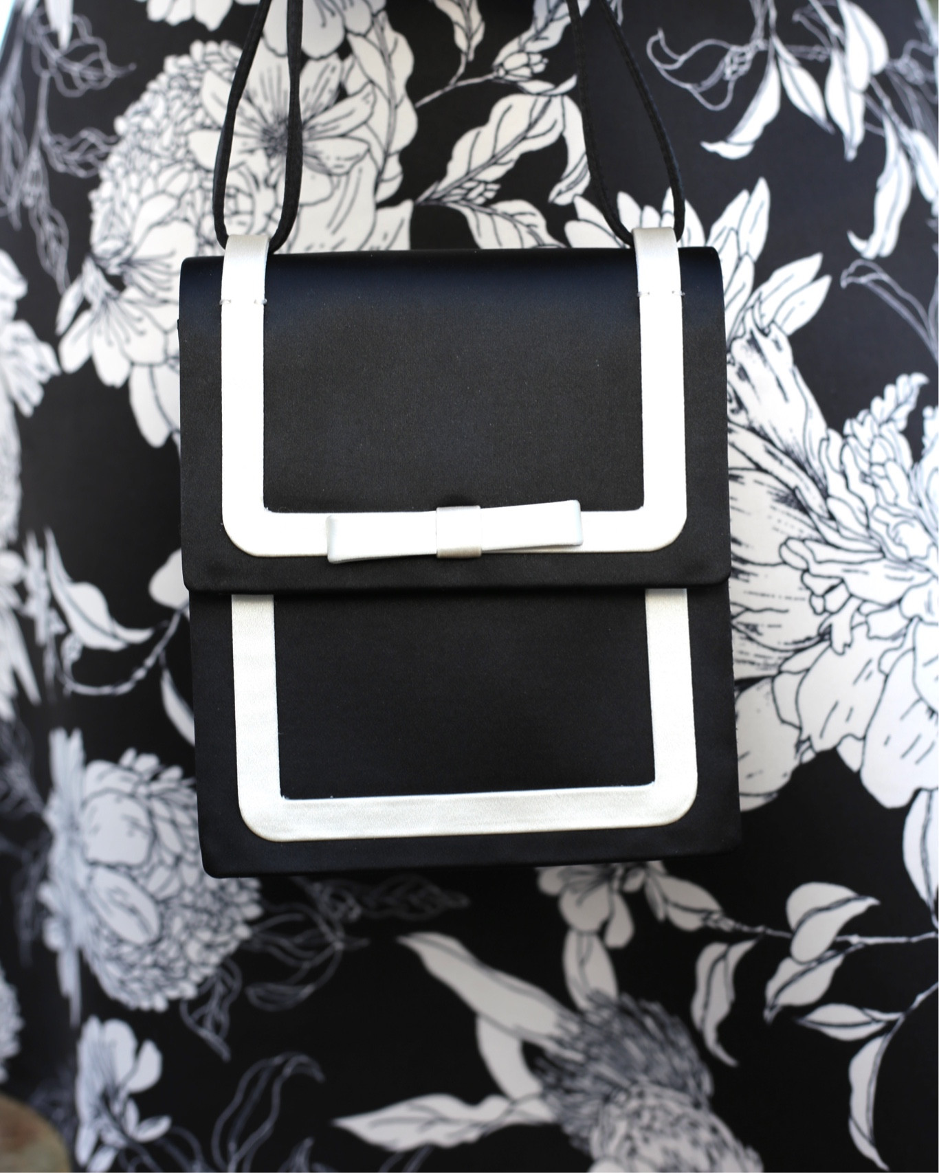 Black and white top handle purse with a tuxedo feel and bow detail. On sale for under $100  

#LTKItBag