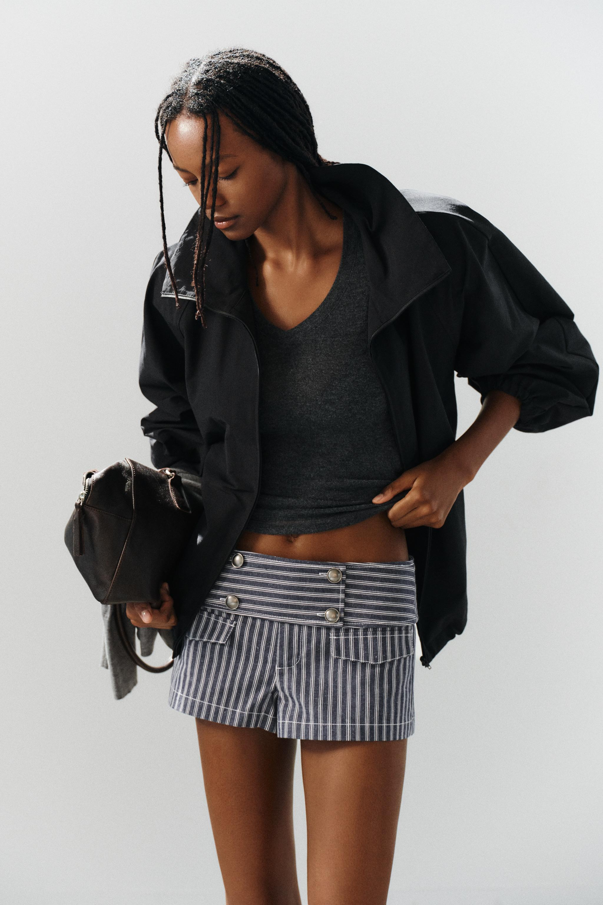 High-neck, long-sleeve jacket with shoulder pads. Features front zip pockets. Hem finished with a... | Zara US
