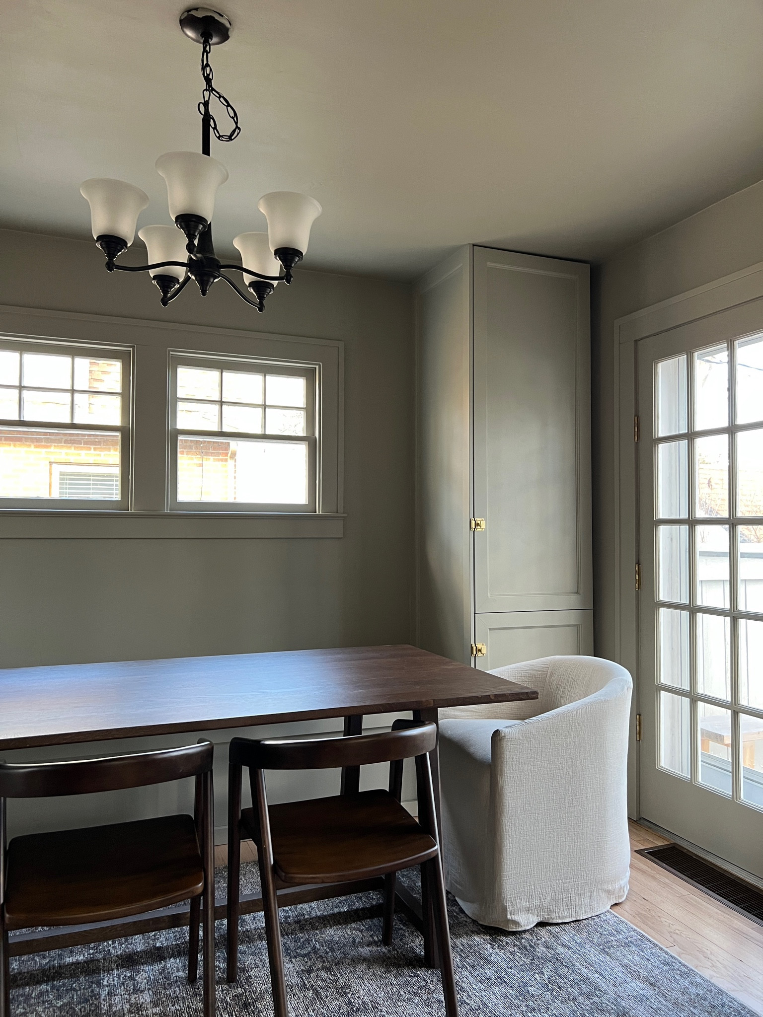 Moody dining room with large dark wood dining table, upholstered dining chairs,  area rug, etc. 

#LTKFind #LTKfamily #LTKhome