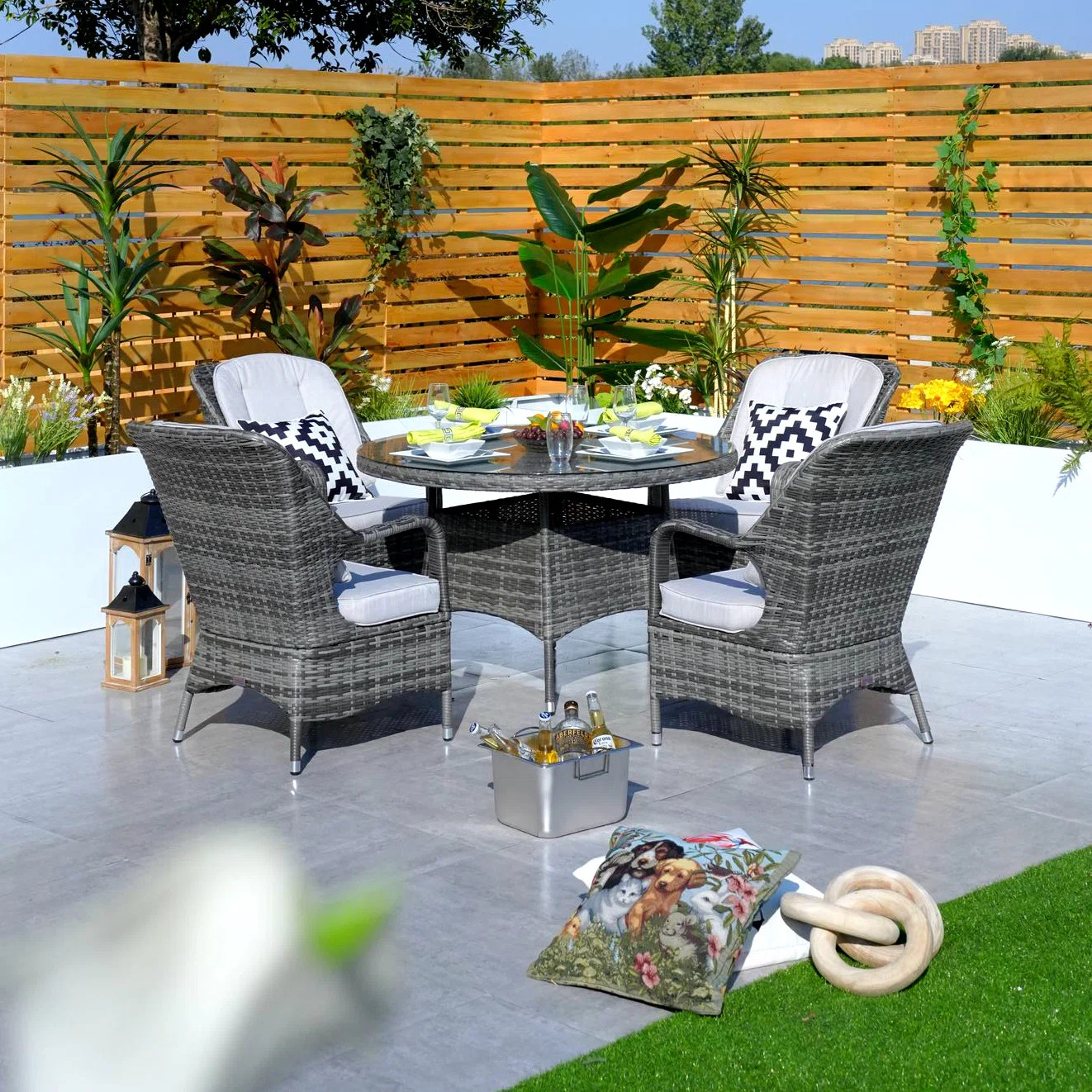 Guyer 4 - Person Wicker Patio Dining Set with Round Table , Cushions Included | Wayfair North America