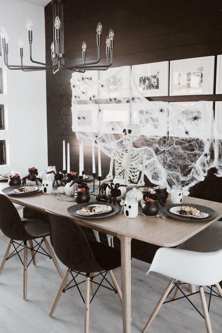 Halloween home decor - black and white decor - fall decor - modern dining room - modern home - Scandinavian style - white photo frames - black chandelier - black chair - white chair 

#LTKhome #LTKunder50 #LTKHalloween