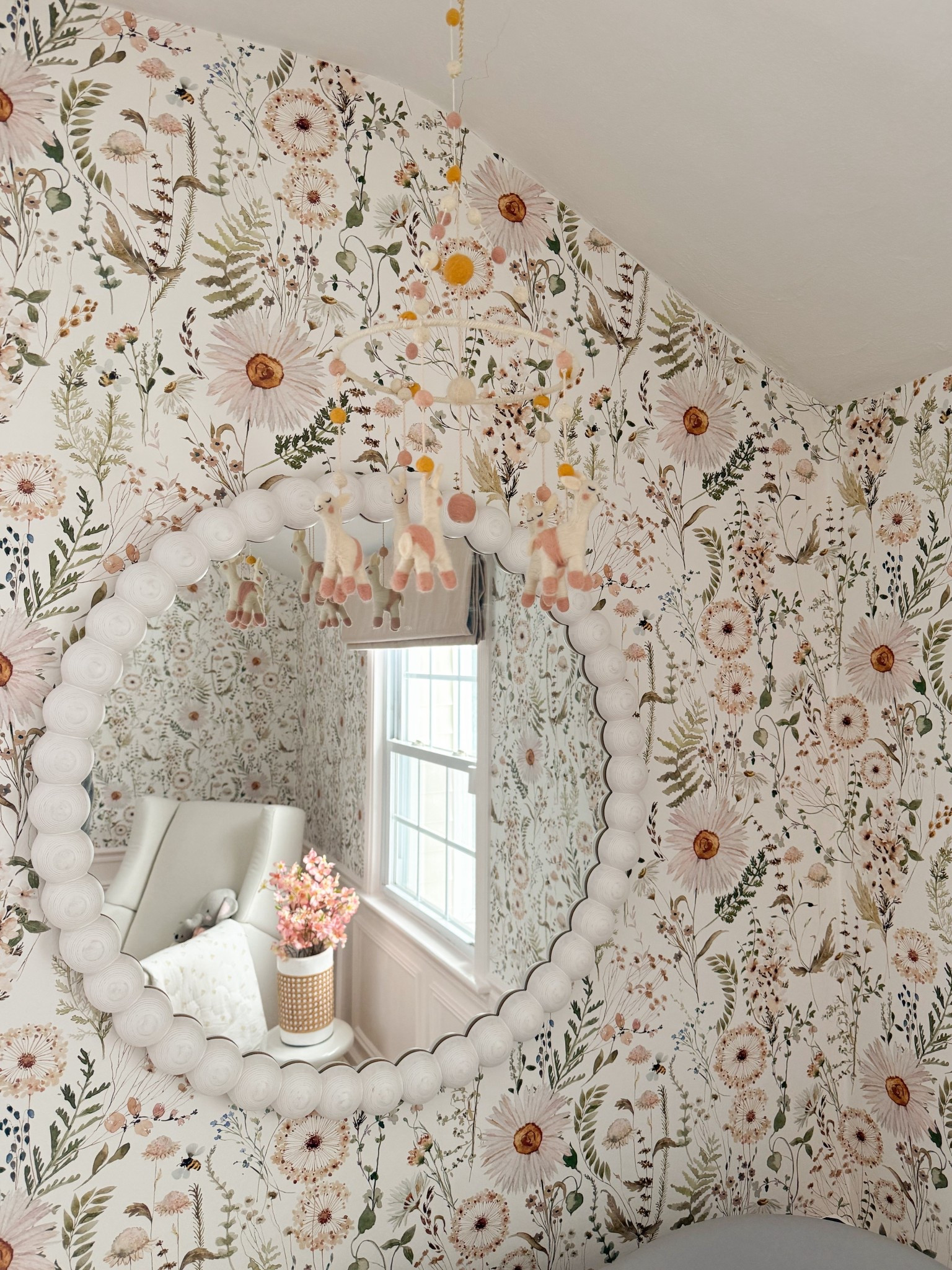 This floral wallpaper paired with the scalloped mirror creates the sweetest focal point, but the hanging mobile is what really brings the space to life. I love how the soft felt details and blush tones add movement and a playful, whimsical touch while still keeping everything elevated and serene. Such a beautiful way to layer texture and charm into a cozy nursery.

floral wallpaper nursery, nursery mobile decor, felt baby mobile, scalloped mirror styling, botanical nursery design, blush nursery ideas, whimsical nursery decor, neutral nursery inspiration, cozy kids room styling, vintage inspired nursery, layered nursery design girlonthehudson

#LTKHome #LTKKids #LTKBaby