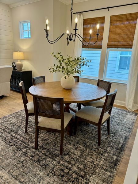 Dining Room, easy dining update, black light fixture, transitional design, cane dining chairs, mixed wood tones, floral stems, navy and green rug, earth tone dining chairs 