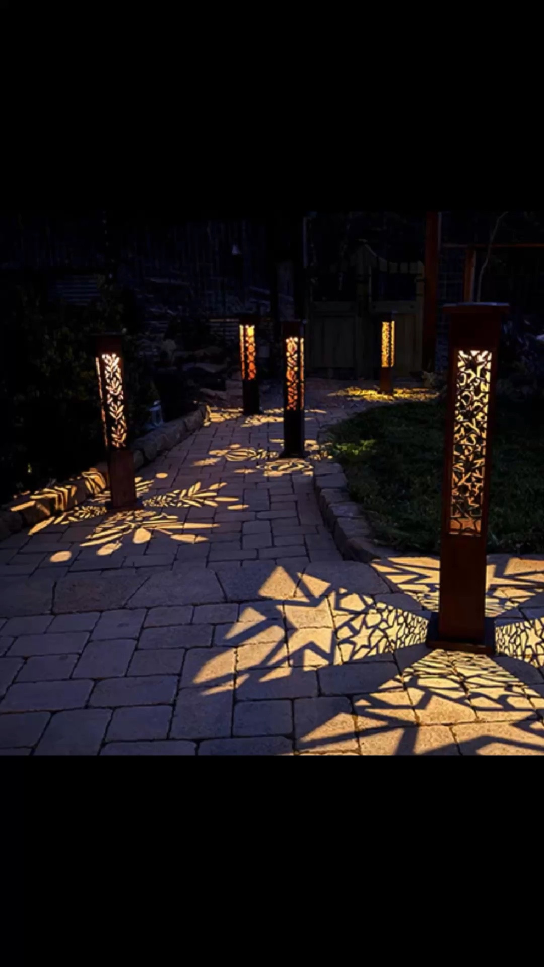 ✨ Shadow Magic for Your Garden
Watch your pathways come alive with dancing star patterns that transform ordinary outdoor spaces into something extraordinary. The Interchange-a-Glow Series creates stunning shadow displays every evening—automatically.
🌟 Mix & Match Your Design
Each 36.5" pillar features interchangeable star cutout panels that cast intricate patterns across patios, walkways, and garden beds. Mix and match the eight included panels (four designs, each 4" x 24") to create your perfect look. Swap them seasonally or whenever the mood strikes.
☀️ Solar-Powered Simplicity
Zero wiring required. Solar-powered lights charge all day and glow all night, casting warm amber light through hand-cut star designs.
🏡 Built to Last Outdoors
Crafted from weather-resistant iron with a rich rust-brown finish that deepens beautifully over time. Set includes two matching pillars, eight interchangeable panels, and built-in solar lights. Each pillar stands 7"W x 7"D x 36.5"H. Outdoor-proof construction means year-round performance.


#LTKHome #LTKSeasonal