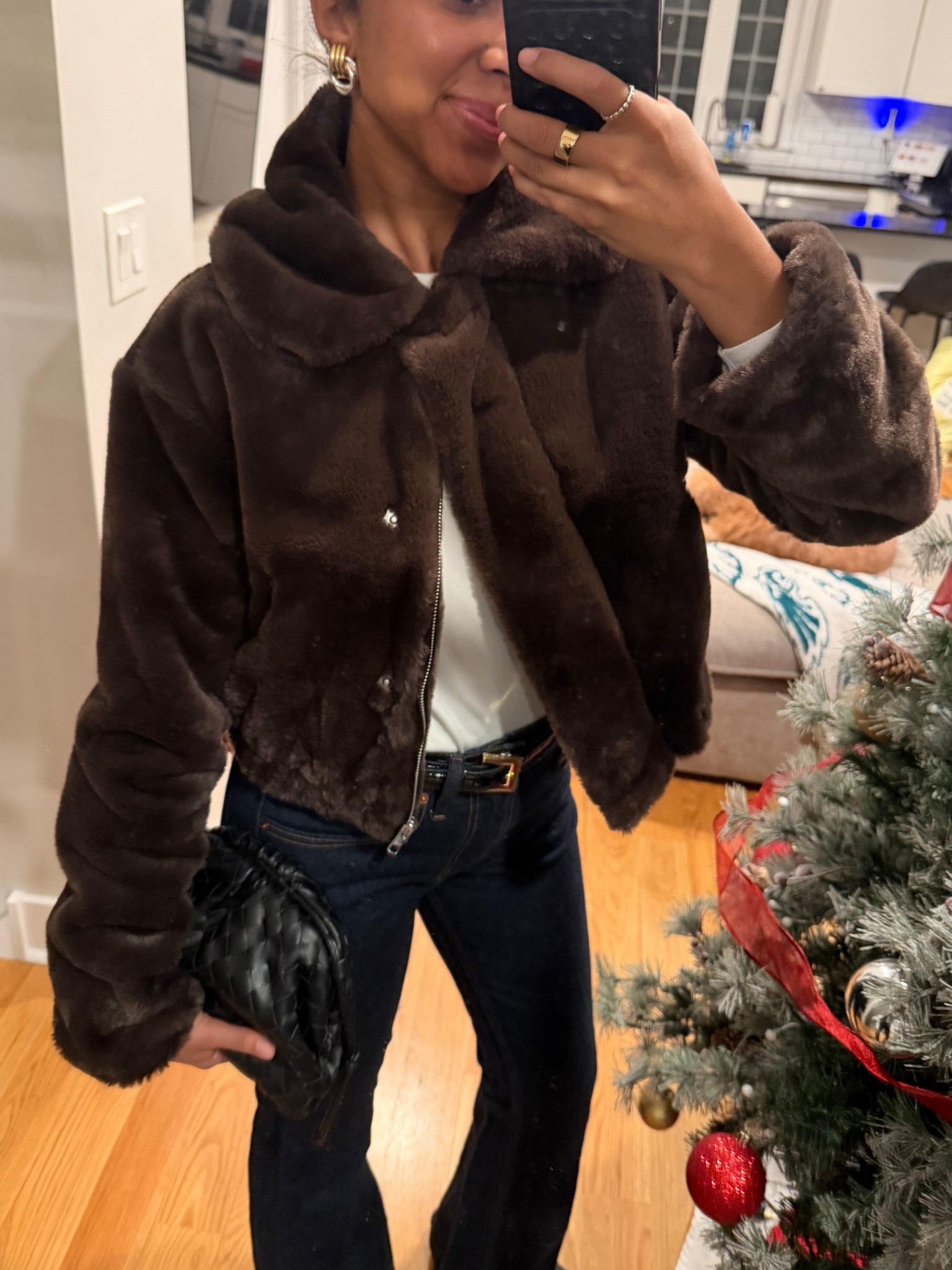 Winter fashion, faux fur jacket, outfit inspo, bootcut jean, black and gold belt, woven bag