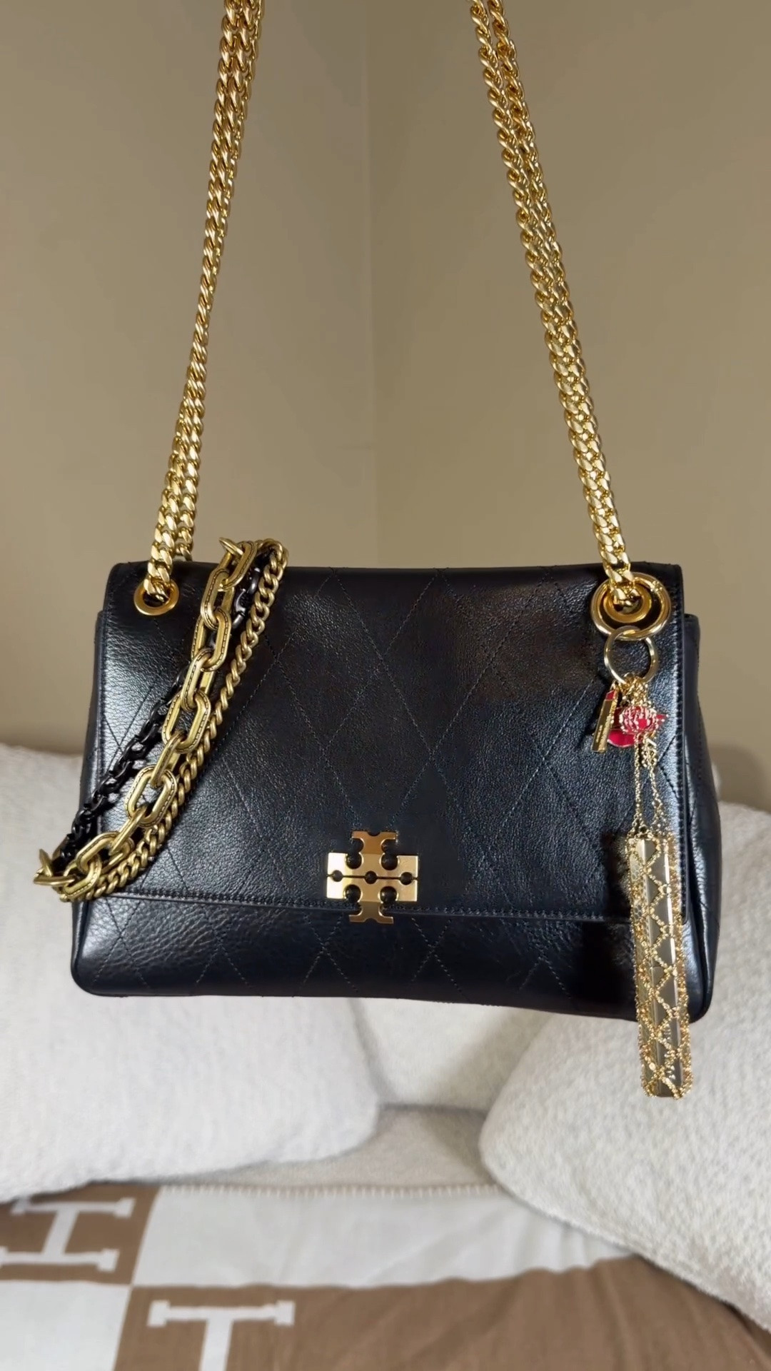 What fits in the medium Tory Burch Charlie shoulder bag 🖤

Large YSL wallet
Pouch of mini makeup (it cosmetics cc cream, KayAli mini perfume, rare beauty blush)
Custom mini hair brush
Touchland hand sanitizer mist
Good shell mirror
Burga magnetic charging bank
Claw clip

I put a coach layered chain charm on it and a chain lipstick holder 🖤