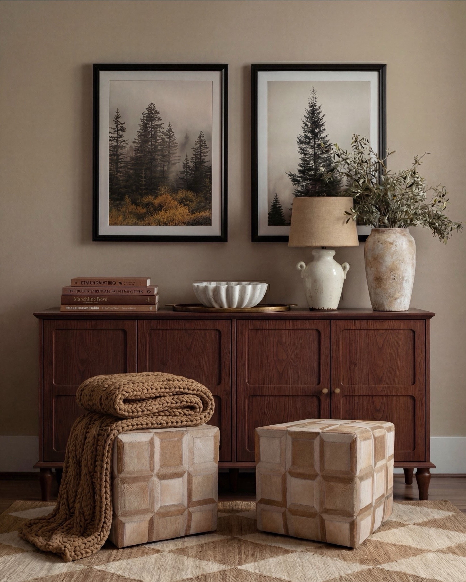 Shop the Look:
• Wood console table
• Framed landscape wall art (black frame)
• Neutral ceramic table lamp
• Stone or ceramic decorative bowl
• Large ceramic vase with faux olive branches
• Textured cube stools (neutral tone)
• Chunky knit throw blanket
• Neutral checkered patterned area rug
• White flitted decor bowl
• Brass oval serving tray
• Brown decor books

#LTKsale #LTKhome #LTKstyletip