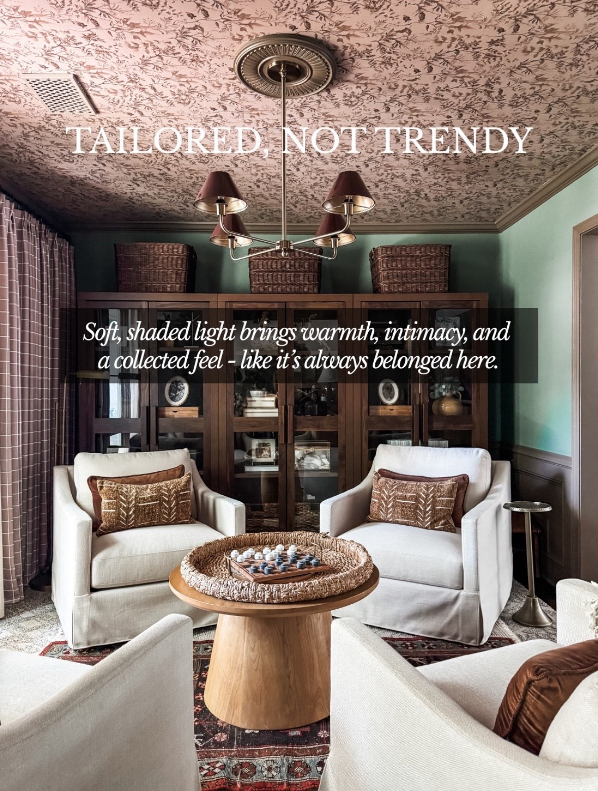 Tailored, not trendy 🤍
This soft shaded chandelier creates the kind of warm, intimate lighting that makes a room feel collected and timeless. The mix of fabric lamp shades, brass chandelier details, and vintage-inspired lighting adds depth against the patterned ceiling wallpaper, wood display cabinets, and neutral upholstered armchairs. Finished with woven baskets, textured throw pillows, a round wood coffee table, and a classic area rug, this space proves that thoughtful lighting is what truly elevates a traditional living room with a modern, layered feel. Linked on LTK ✨

#eanesinteriors #softlighting #shadedchandelier #fabriclampshades #brasslighting #patternedceiling #traditionalinteriors #timelessdesign #neutralfurniture #woodfurniture #wovenbaskets #layeredinteriors #cozylivingroom #LTKhome #LTKfinds

#LTKstorytime #LTKOver40 #LTKHome