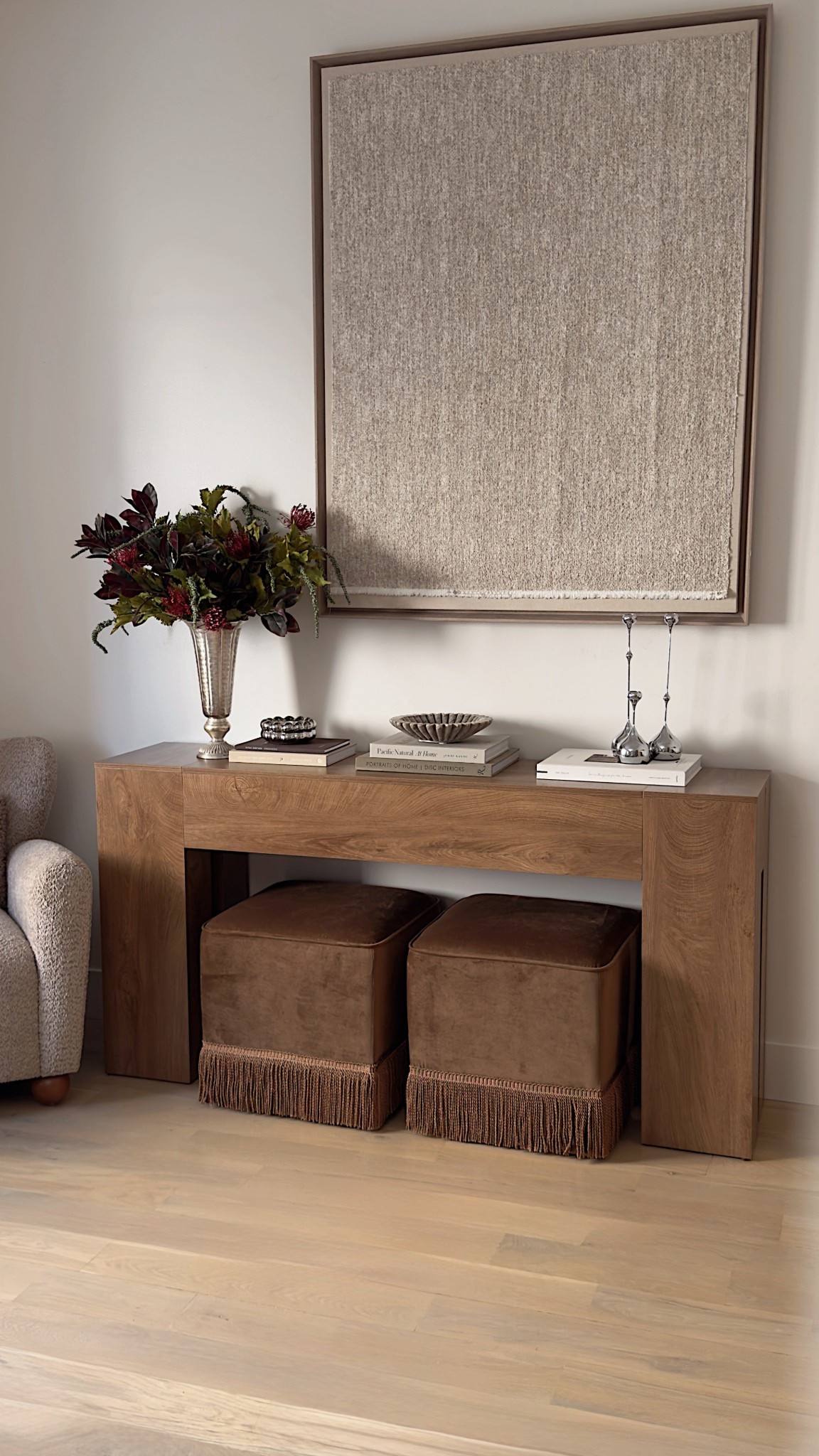 Get this entire whole designer look styling but for way less 🤩🤩

Console table
Neutral wall art
Ottomans
Stems 
Decor 
Accent chair 

#LTKHome