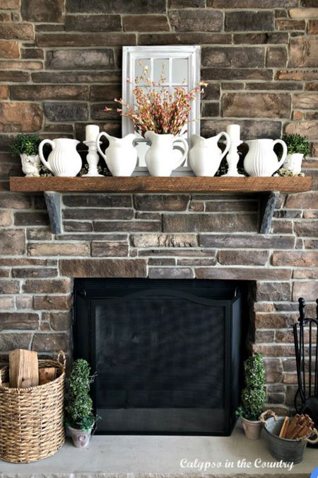 Spring fireplace mantel decorating idea - white pitchers and window pane mirror!

#LTKstyletip #LTKhome #LTKSeasonal