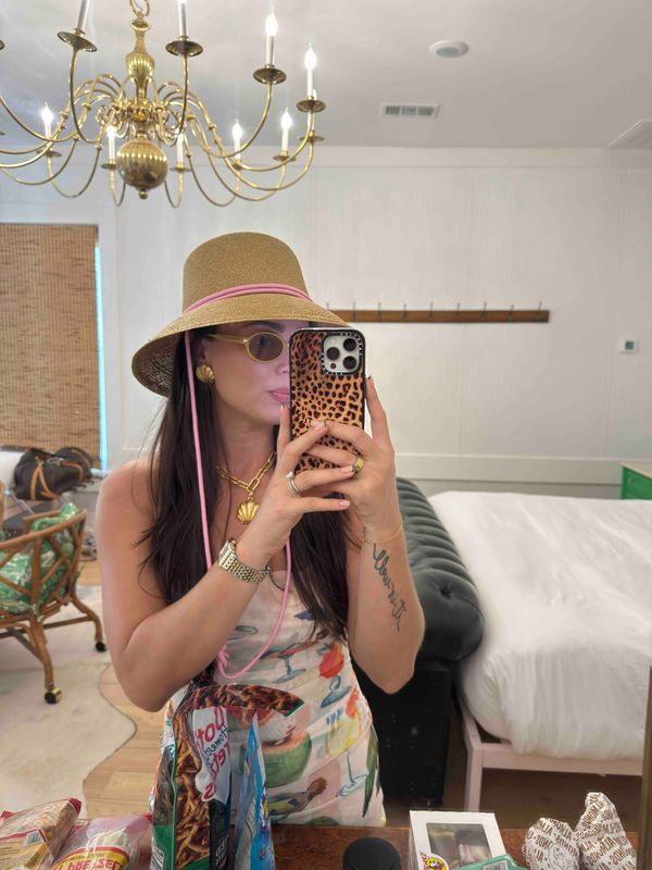 vacation mode fully activated 🌴👒 obsessed with this whole moment — the straw bucket hat with the pink band, the printed dress, gold shell necklace, and leopard Casetify case tying it all together. the accessories are doing everything here. all pieces linked 

 