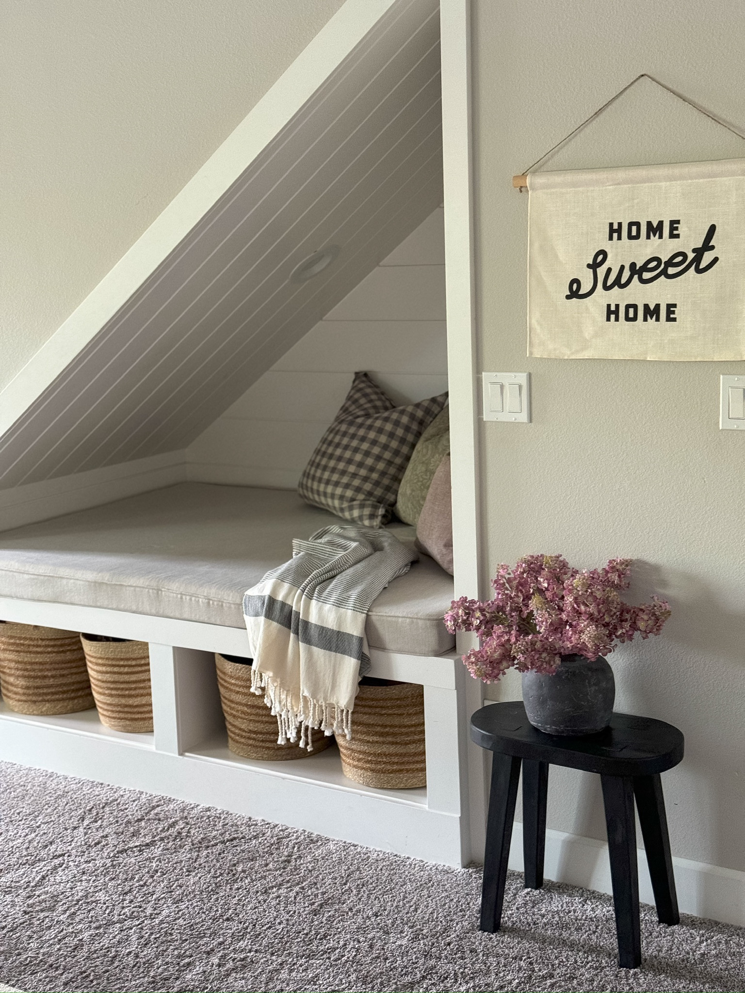 I love this little nook underneath our stairs in our basement! I added these real touch faux pink lilacs I just got in the mail to this space, and it instantly brightens it up! 

#LTKSeasonal #LTKhome #LTKstyletip