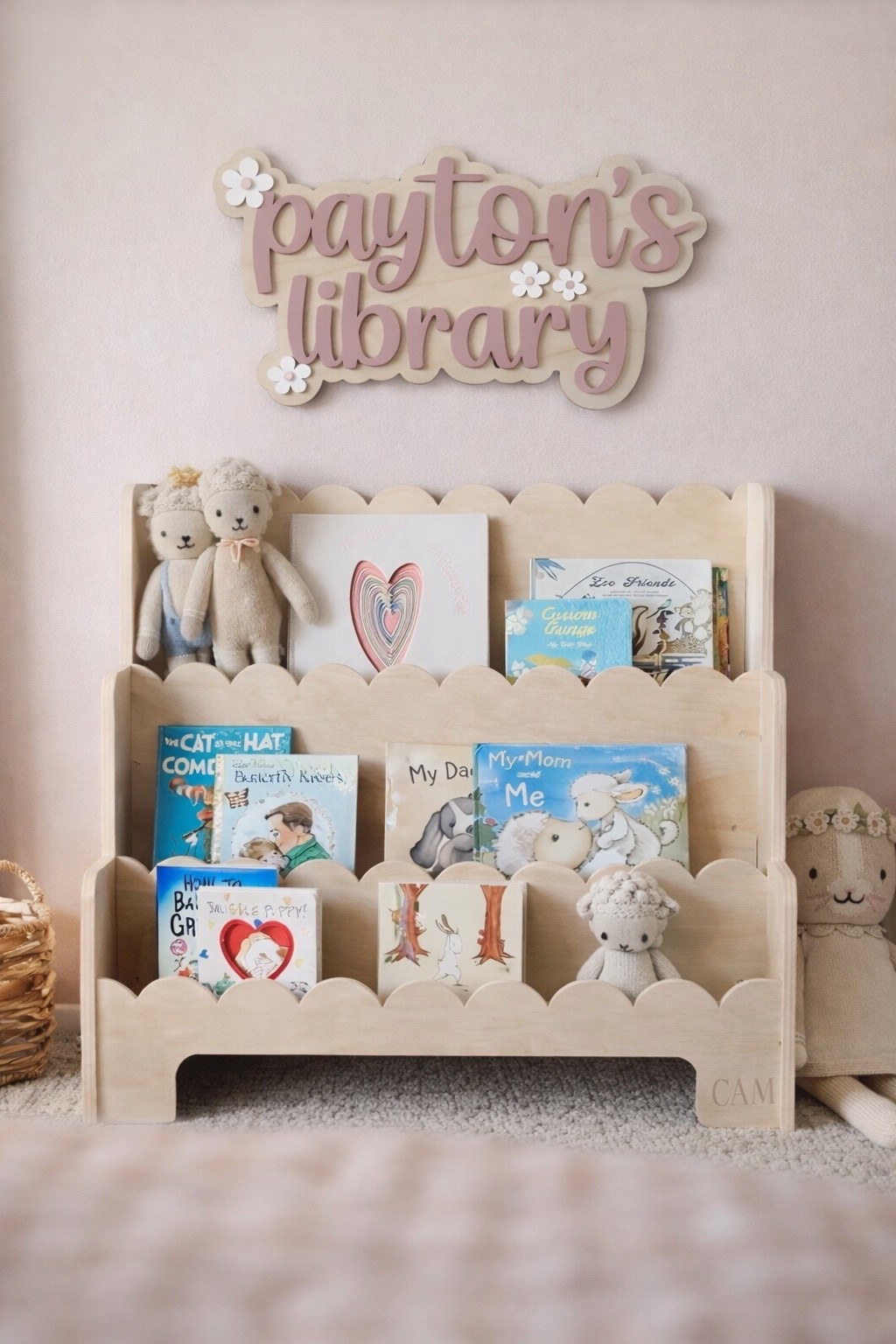Sweet and simple kids book nook setup featuring a layered wooden name sign and toddler front-facing bookshelf. Personalized wall decor adds a custom touch to any nursery or playroom and helps create a cozy reading corner kids actually use. Perfect for Montessori-style spaces, toddler rooms, and baby girl nursery themes. Neutral wood + soft pink keeps it timeless and easy to match with existing decor. 

#nurserydecor #kidsroomdecor #playroomdecor #montessorishelf #kidsbookshelf #personalizedsign #namewallsign #nurserywallart #toddlerroom #readingcorner #booknook #girlroomdecor #neutralnursery #wooddecor #customkidsdecor #homedecorkids #nurseryideas #playroomideas #kidsroominspo

#LTKBump #LTKKids #LTKBaby