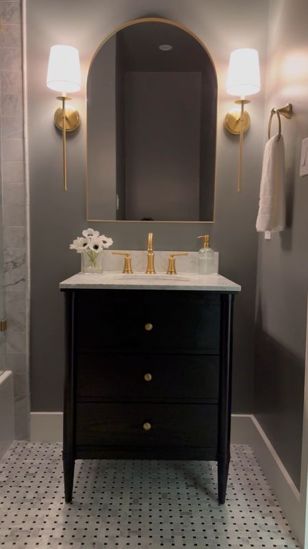 Moody hallway bathroom decor details 🖤 

black vanity, brushed gold, aged brass, arch mirror, bathroom sconces, shower, faucet, small bathroom ideas, Amazon, Pottery Barn

#LTKsalealert #LTKstyletip #LTKhome