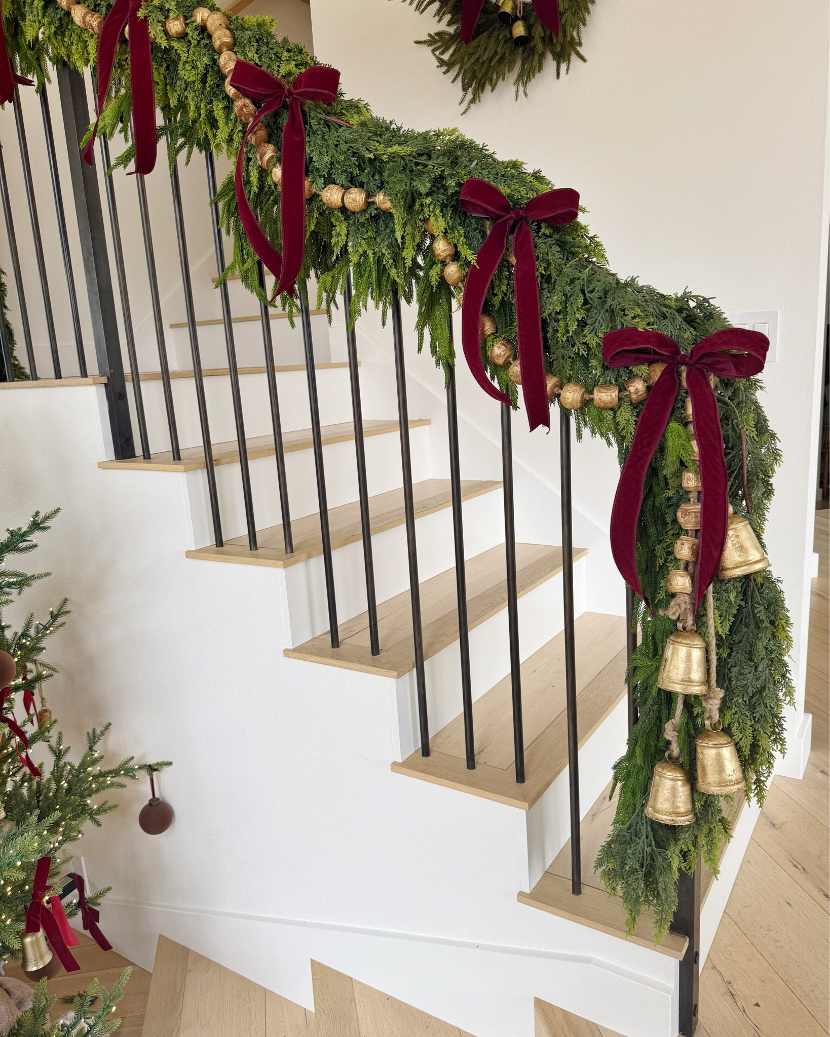 Christmas staircase styling with green garland (Afloral and Amazon), wood beads, a set of bells and velvet burgundy bows!!🤶🏻💫🔔

Holiday
Home decor 

#LTKFindsUnder50 #LTKHoliday #LTKHome