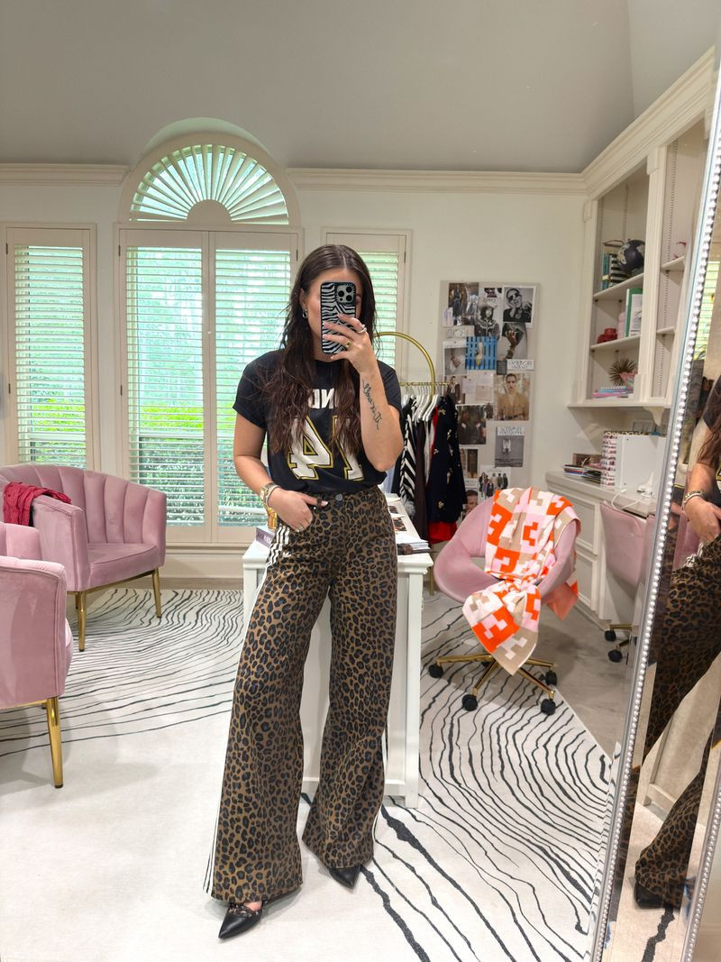 leopard print wide leg jeans + a gameday tee = the combo I didn't know I needed 🐆🖤 styled with my Michele watch and the zebra Casetify case that matches the whole animal print vibe — this is the kind of outfit that looks like you tried without trying at all. #sports  

 