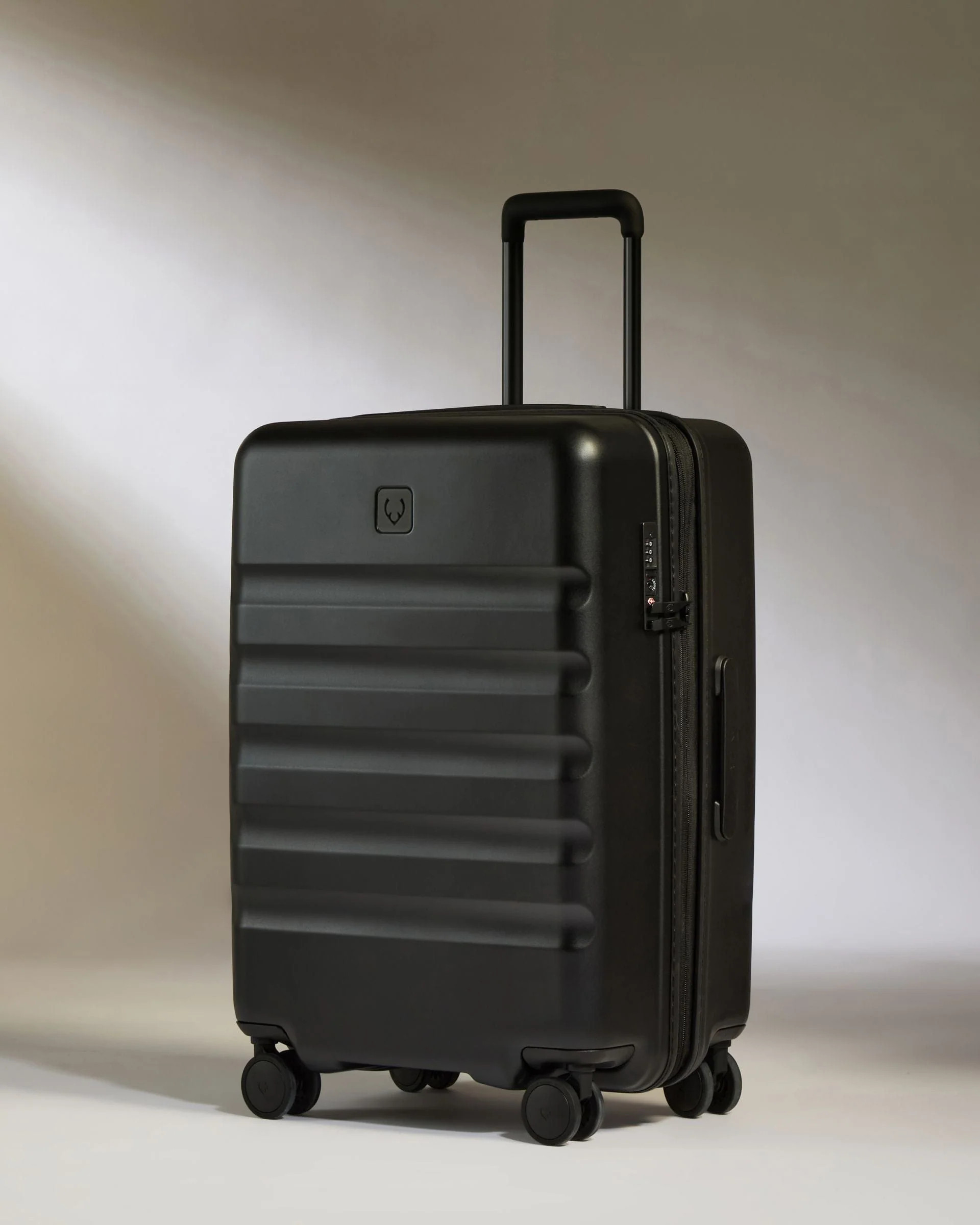 Medium suitcase in Black - Icon Stripe | Lightweight & Hard Shell Suitcase | Antler UK