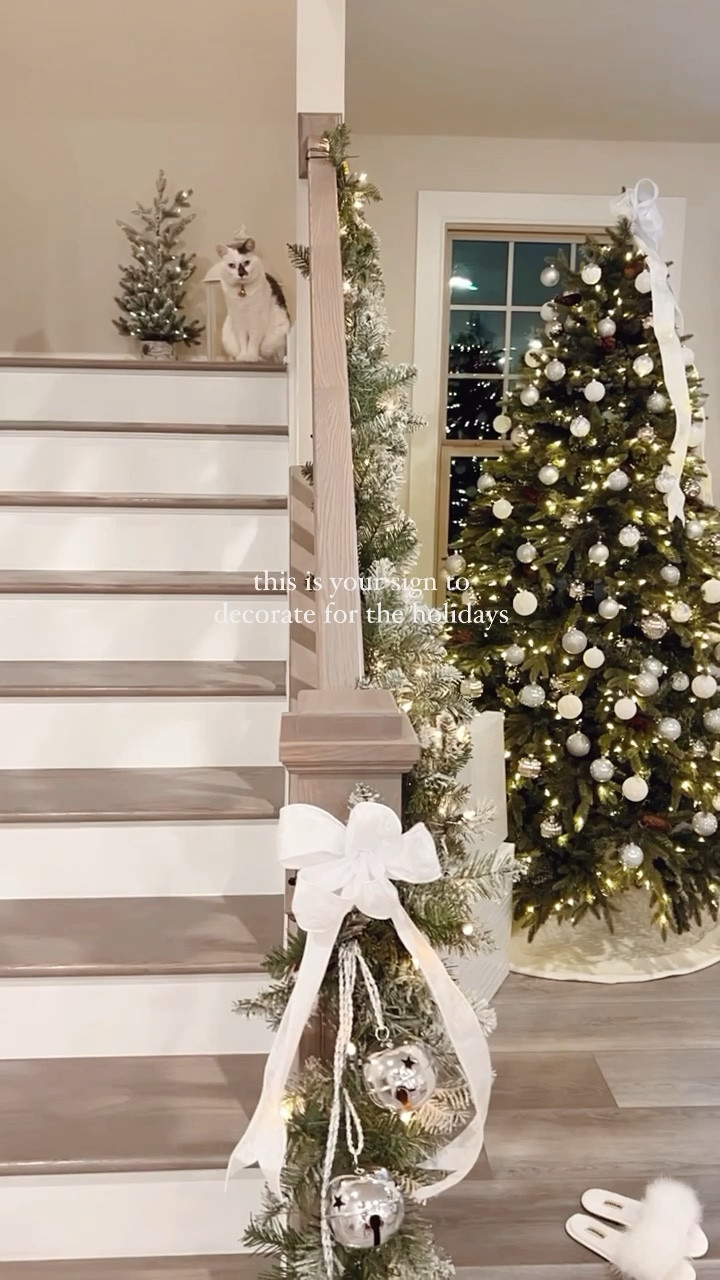 Christmas tree decorations + holiday decor that will cozy up your space this holiday season🎄✨

Here, we decorated our artificial Christmas tree with white and silver ornaments for a glitz + glam holiday look. I used white and silver wrapping paper to match when placing presents under the Christmas tree. We used a white cable knit tree skirt. I made the Christmas tree topper bow from white and silver wired ribbon. 

We added more texture to cozy up our living room with a white faux fur rug infront of the fireplace. We hung flocked garland and green stockings along the mantel. We wrapped matching flocked garland around the stair railings. At the end of each banister, I added a white and silver wired ribbon bow and silver jingle bells. 

The flocked artificial mini tree and white lantern helped add classy Christmas decor to our home. We hung green and plaid blankets from our blanket ladder. We added matching green pillow covers on the throw pillows on the couch. 

#LTKSeasonal #LTKHome #LTKHoliday