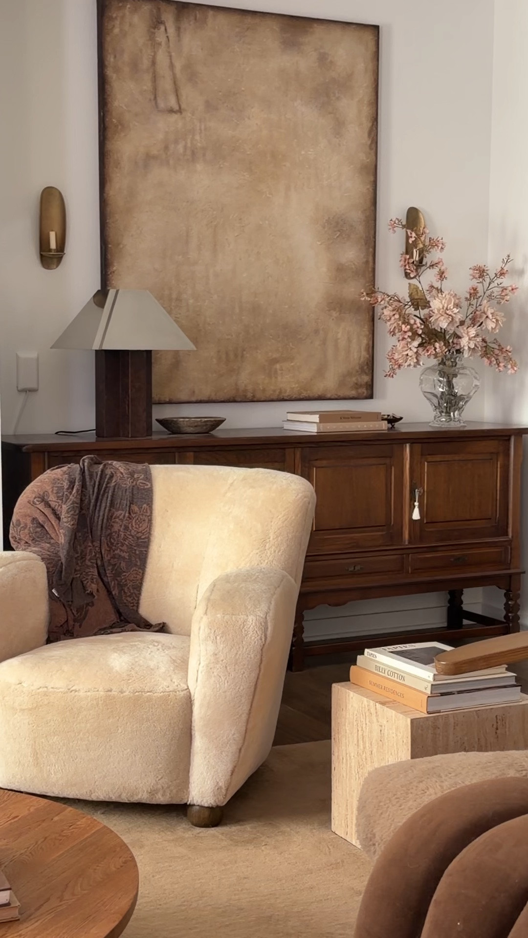 living room 

shearling armchair, table lamp, wool rug, travertine table, candle sconce

#LTKHome #LTKSaleAlert