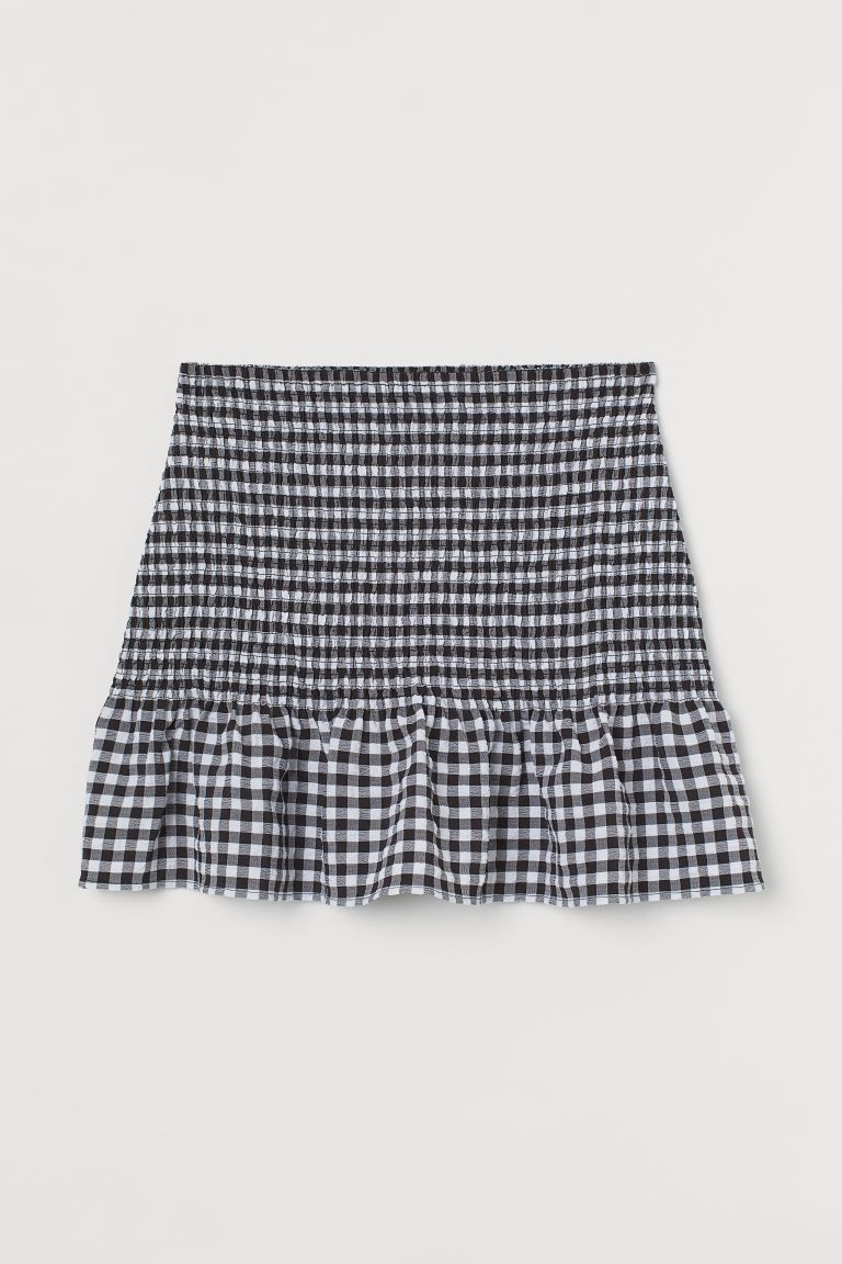 Short skirt in woven fabric. Narrow, elasticized waistband, smocking at upper section, and seam w... | H&M (US + CA)