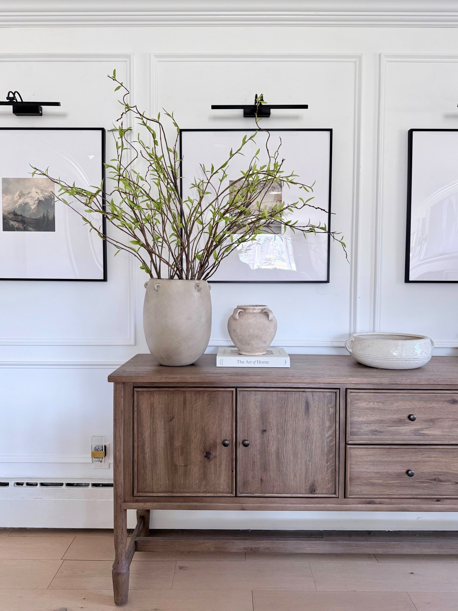 Organic modern sideboard styling & gallery wall. 🤎

tall faux branches | spring greenery | vase | lighting | decorative bowl | storage | wall art | living room | entryway

#LTKHome #LTKActive #LTKSaleAlert