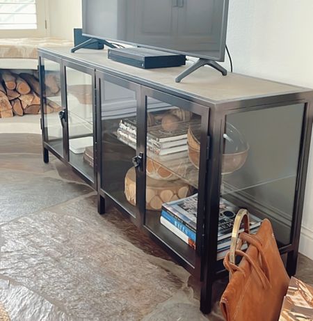 We love our metal and glass media console cabinet. This one is discontinued from Pottery Barn so I linked some similar options here. 

#mediacabinet #mediaconsole #mediacenter 

#LTKFind #LTKhome