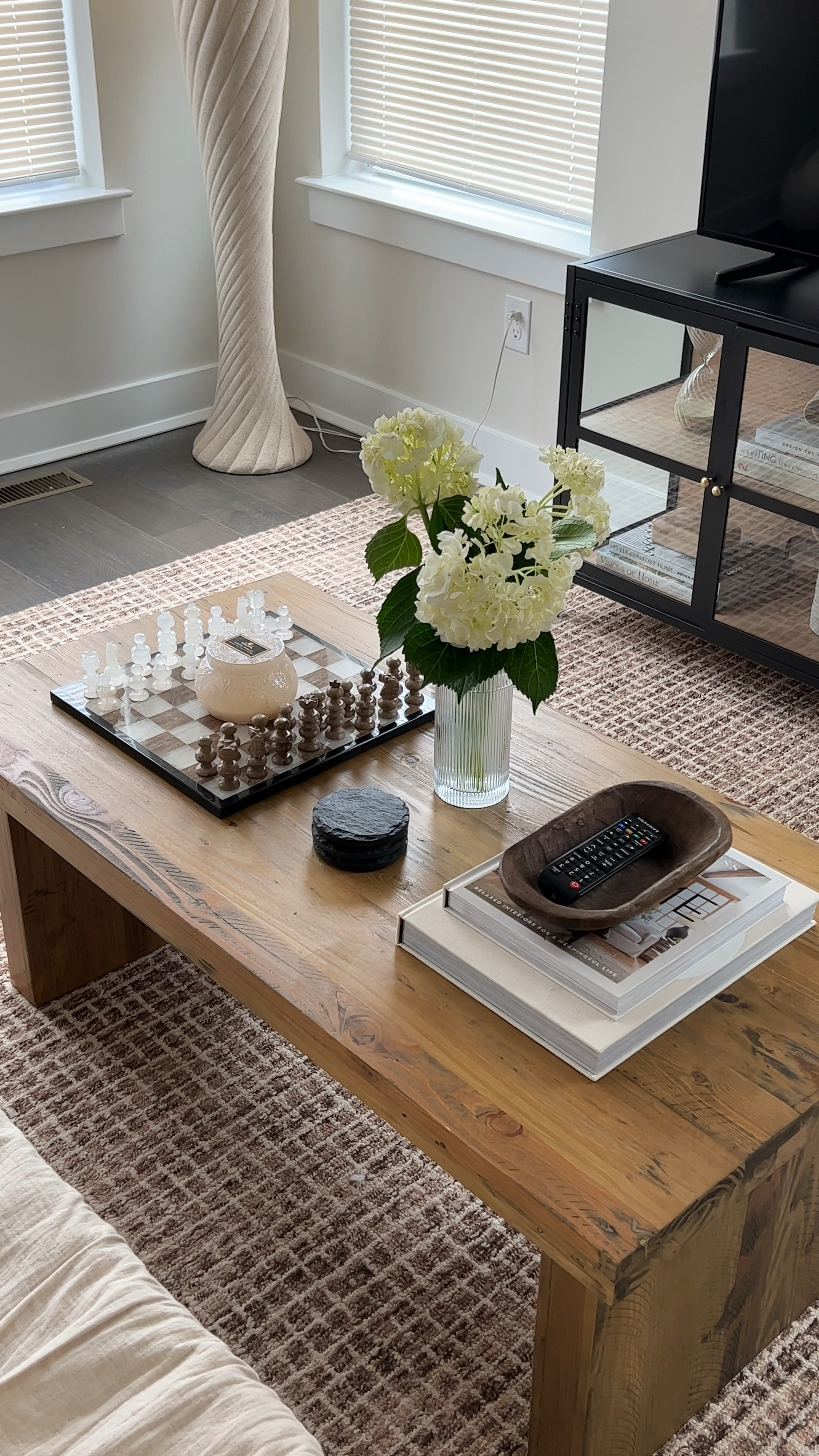 Still working on styling the living room 🫶🏼 linked what I could Checkered rug, grid rug, area rug, neutral area rug, neutral living room rug, brown rug, media console, glass console, console table

