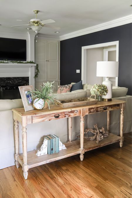 This light wood sofa table is great for lamps that provide lighting to the sectional and for setting coffee mugs on, and more. It’s the piece of furniture first seen when entering the room from the kitchen, so I like to keep it decorated. 

#LTKhome