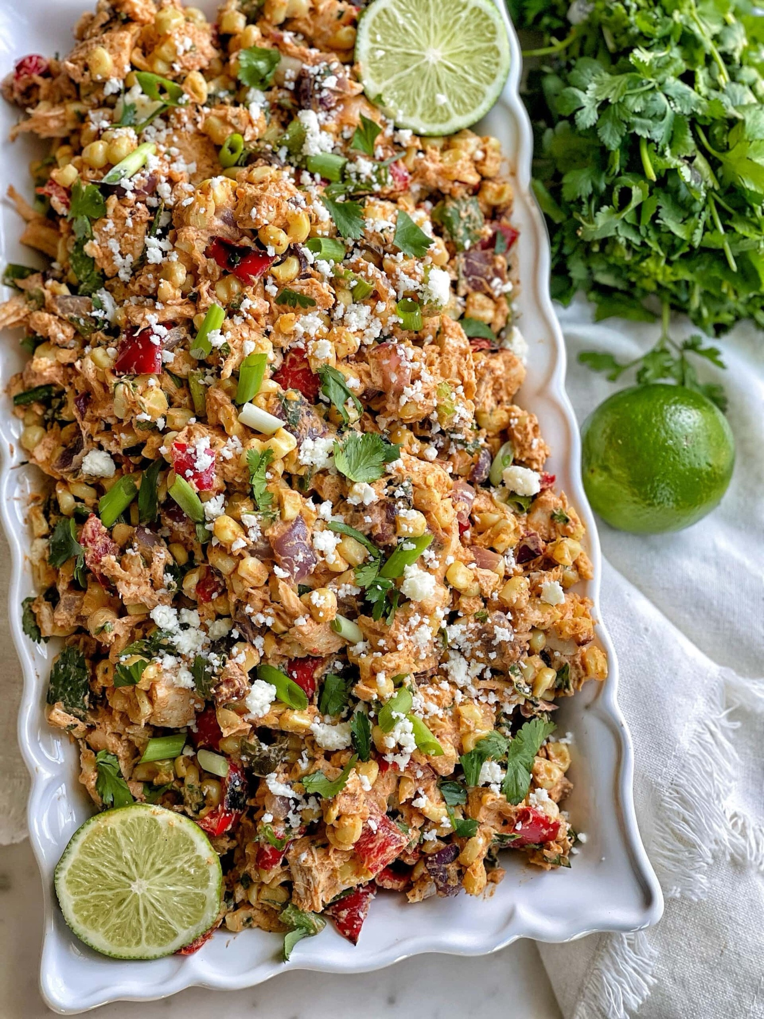 This chicken salad recipe has all of the components of street corn: roasted corn kernels, hints of chili and lime, fresh cilantro, and of course, crumbly Cotija cheese. Combined with delicious roasted red peppers, jalapeno, red onion, and tender chunks of cooked chicken breast in a creamy dressing with lime juice, this chicken salad is bursting with flavor.  Healthy street corn-inspired chicken salad is bursting with flavor, you’ll never guess that this recipe is lightened-up.  Serve on top of greens, alongside crackers and carrots for dipping, or in your favorite wrap or roll for the best lunch ever. Healthy Street Corn-Inspired Chicken Salad: full recipe on www.sweetsavoryandsteph.com.


#LTKFindsUnder50 #LTKSeasonal #LTKHome