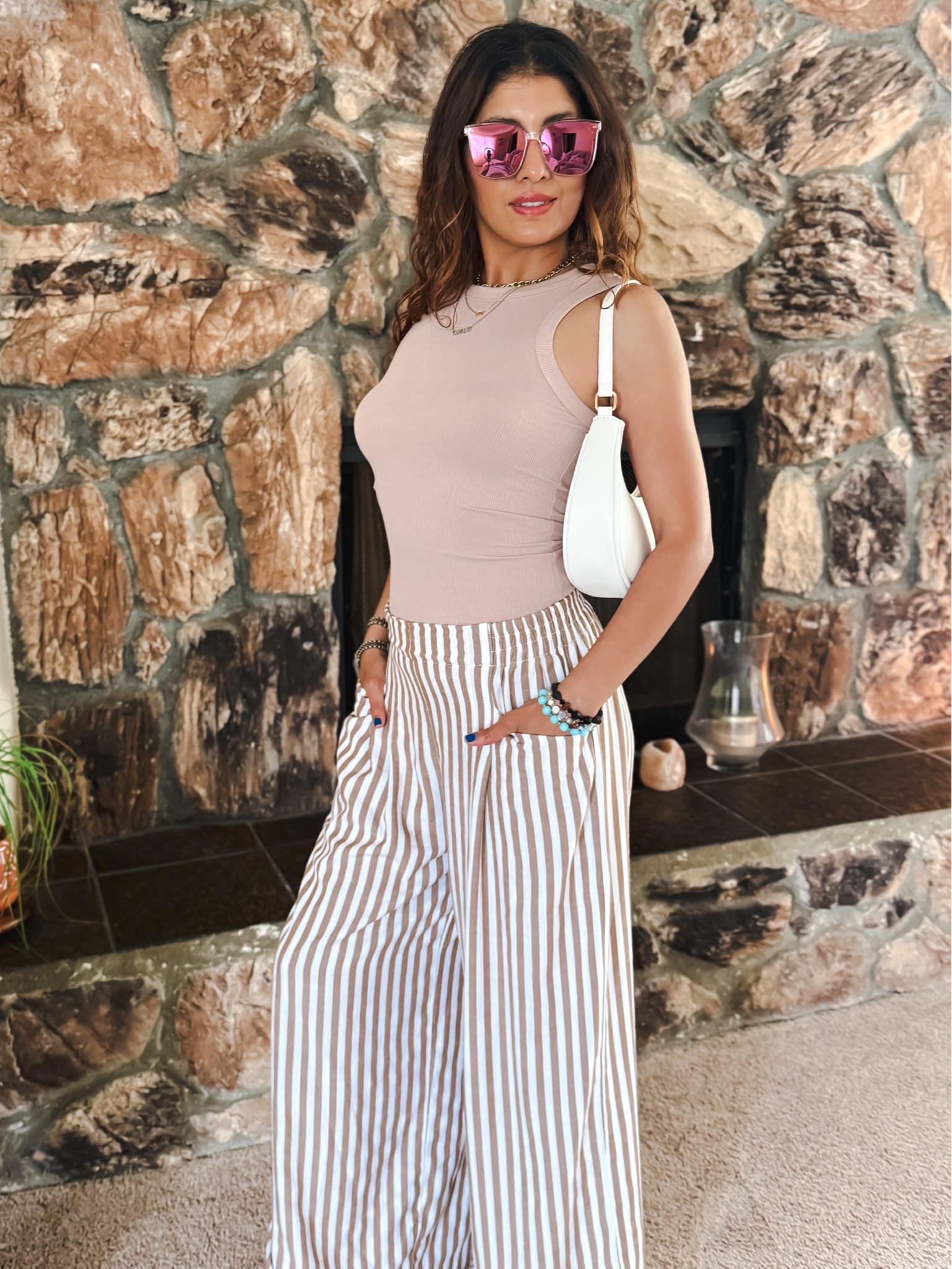 Neutral outfit perfection 🤍 These striped palazzo pants are lightweight, flattering, and so easy to style for spring & summer. Paired them with a fitted ribbed tank, mini shoulder bag, and oversized sunnies for an effortless chic everyday look. Perfect for brunch, vacation, errands, or a casual date night outfit. #LTKStyle #OOTD

striped palazzo pants, wide leg pants outfit, neutral outfit, beige tank top outfit, spring fashion, summer outfit inspiration, chic casual outfit, effortless style, vacation outfit, resort wear, everyday fashion, womens style over 40, classy casual outfit, comfy chic look, ribbed tank top, striped trousers, minimalist fashion, neutral aesthetic, brunch outfit, coastal chic style

#LTKootd #LTKPetite #LTKMidsize