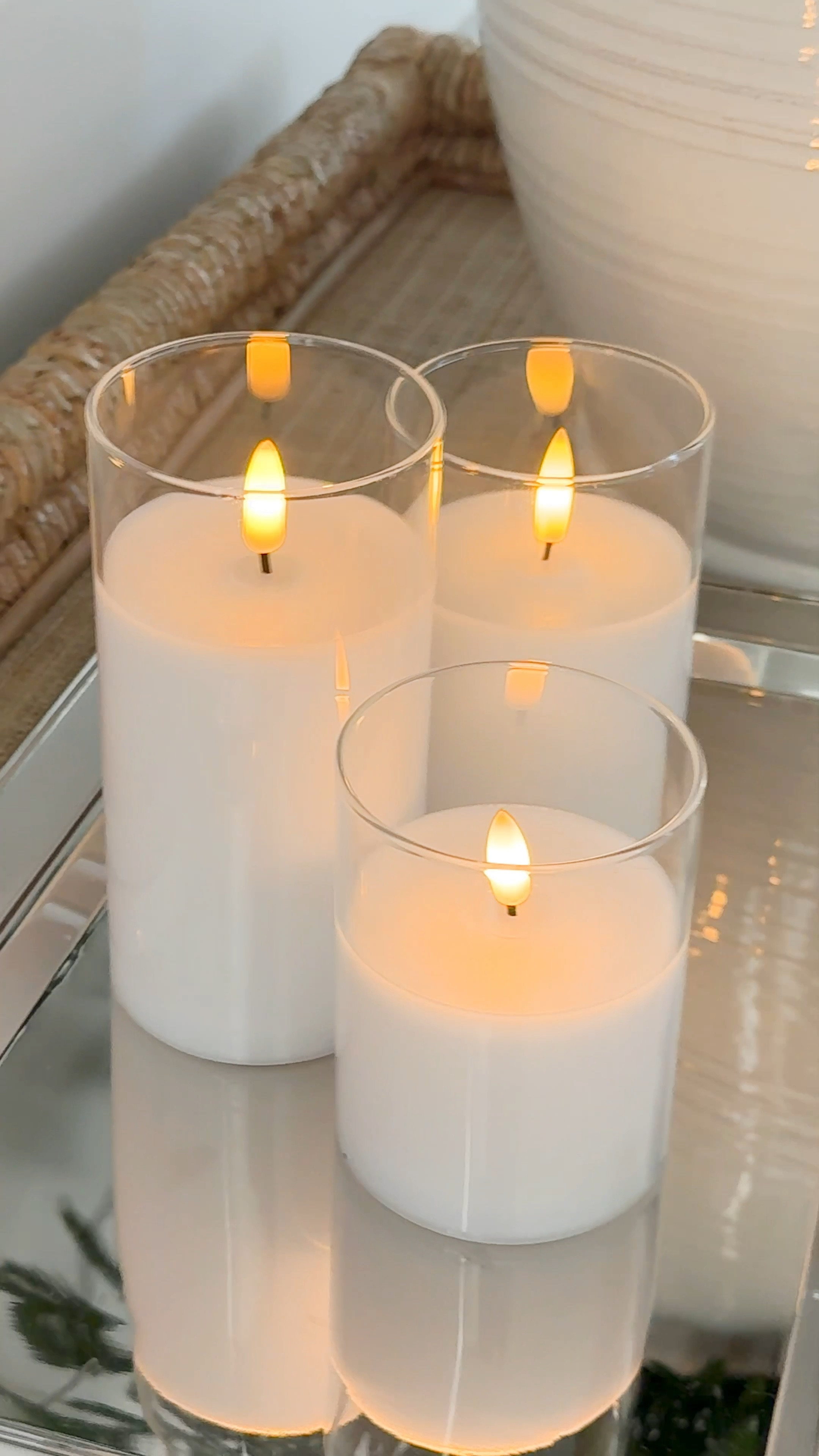 Loving these flameless look for less candle pillars! They come in several color options and come with a remote that has a timer, solid or flickering light option, dimmer and more! Also linking our Pottery Barn set along with our favorite flax evergreen stems, ceramic vase, raffia tray and silver tray set! #ltkholiday #ltkhome #ltksalealert #ltkfindsunder50 #ltkfindsunder100 #ltkstyletip #ltkseasonal

#LTKWatchNow #LTKHoliday #LTKHome